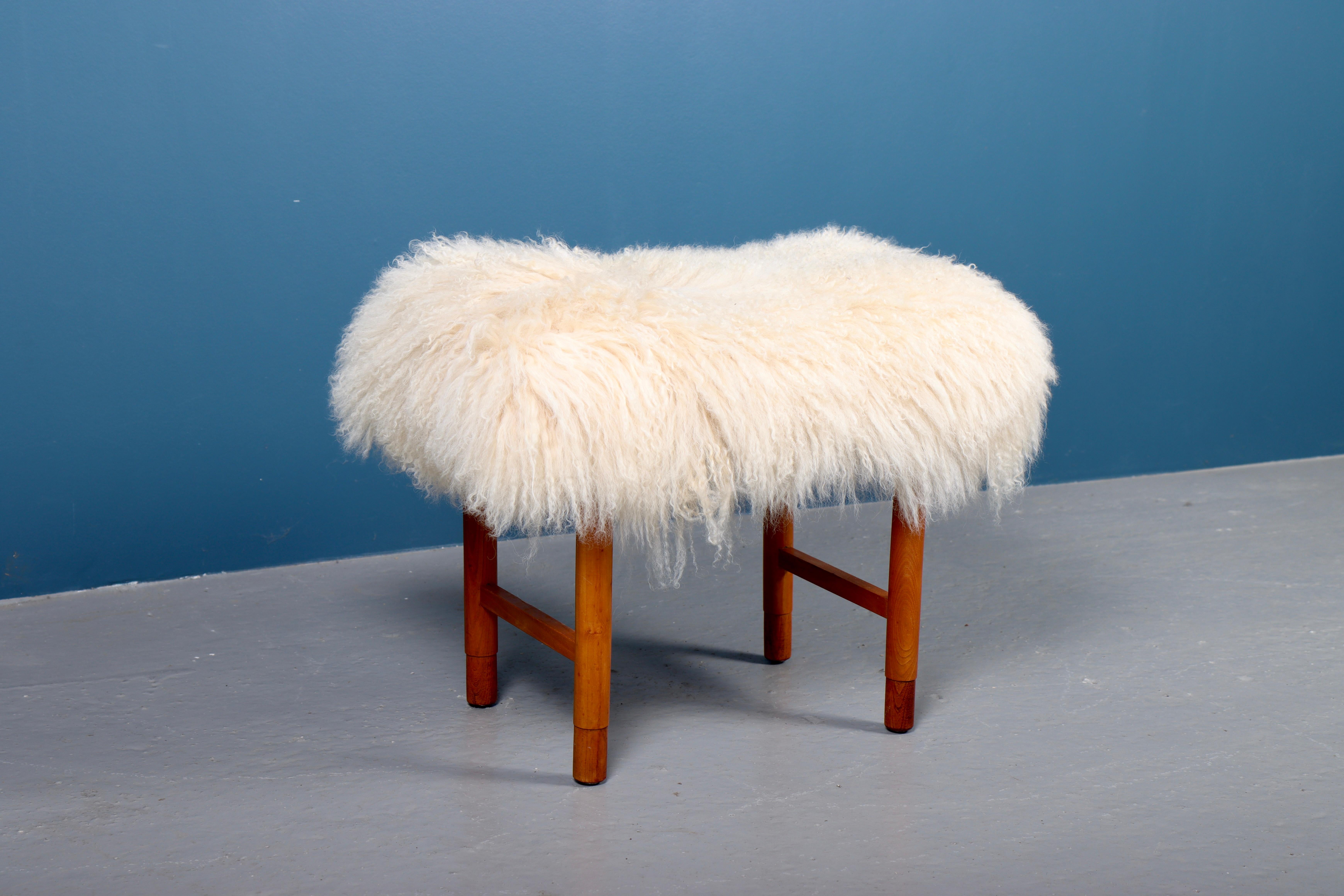 Ottoman reupholstered with sheepskin. Designed and made in Denmark. Great condition.