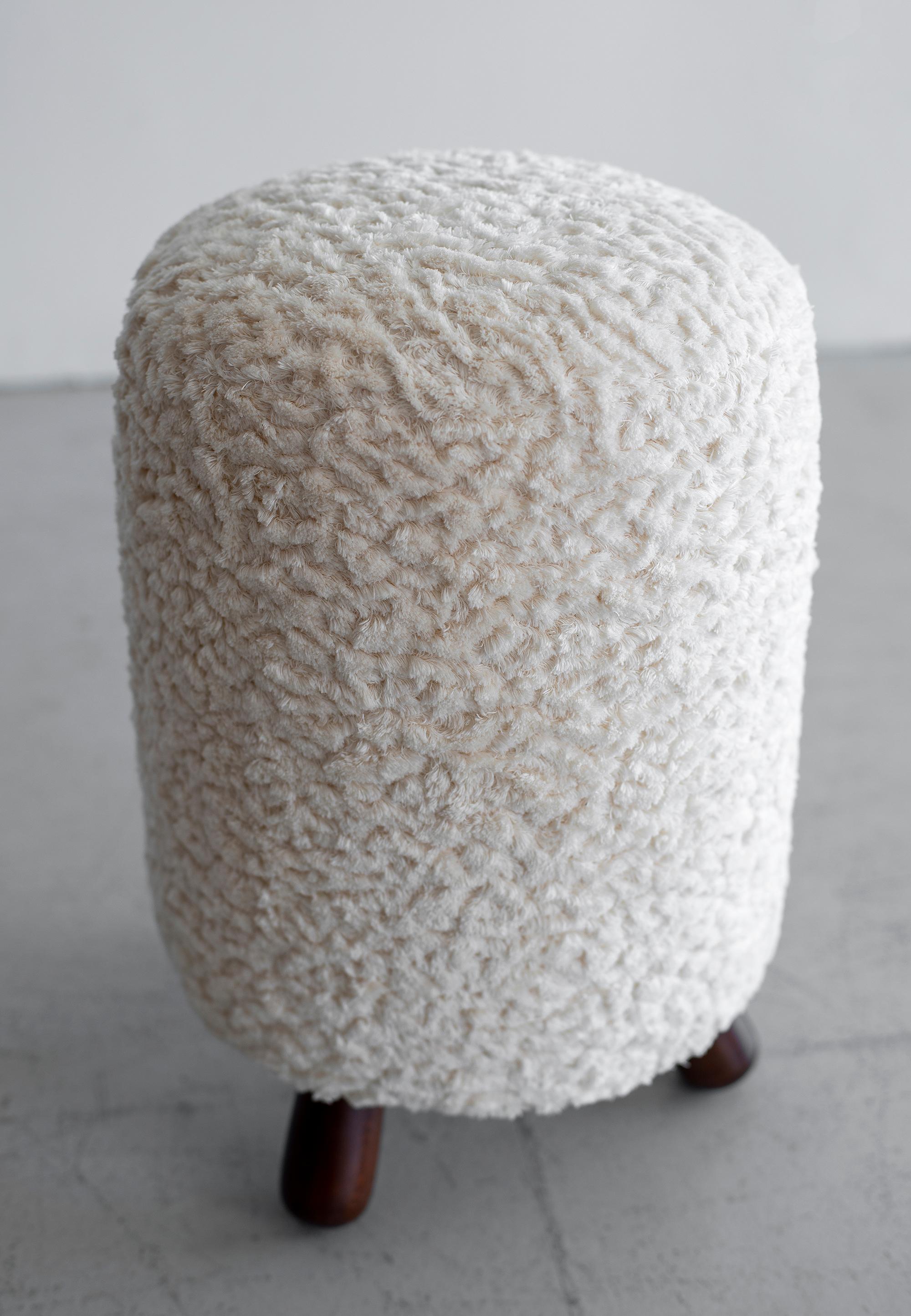 Great shaped stools with tripod legs.
Reupholstered in textured wooly boucle fabric.