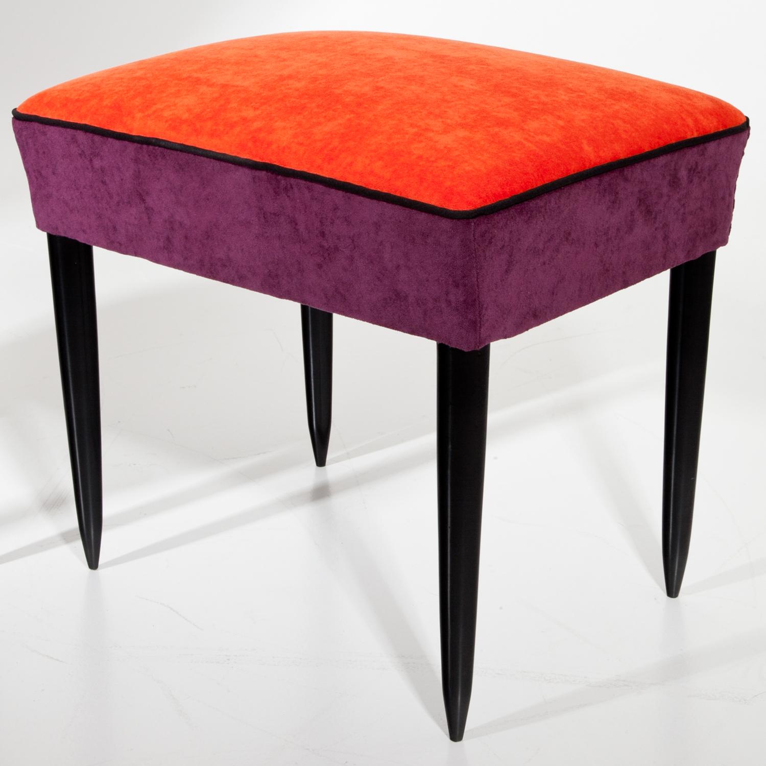 Pair of stools standing on ebonized conical legs with rectangular seats. The stools were reupholstered with a velet-like fabric in purple and orange.