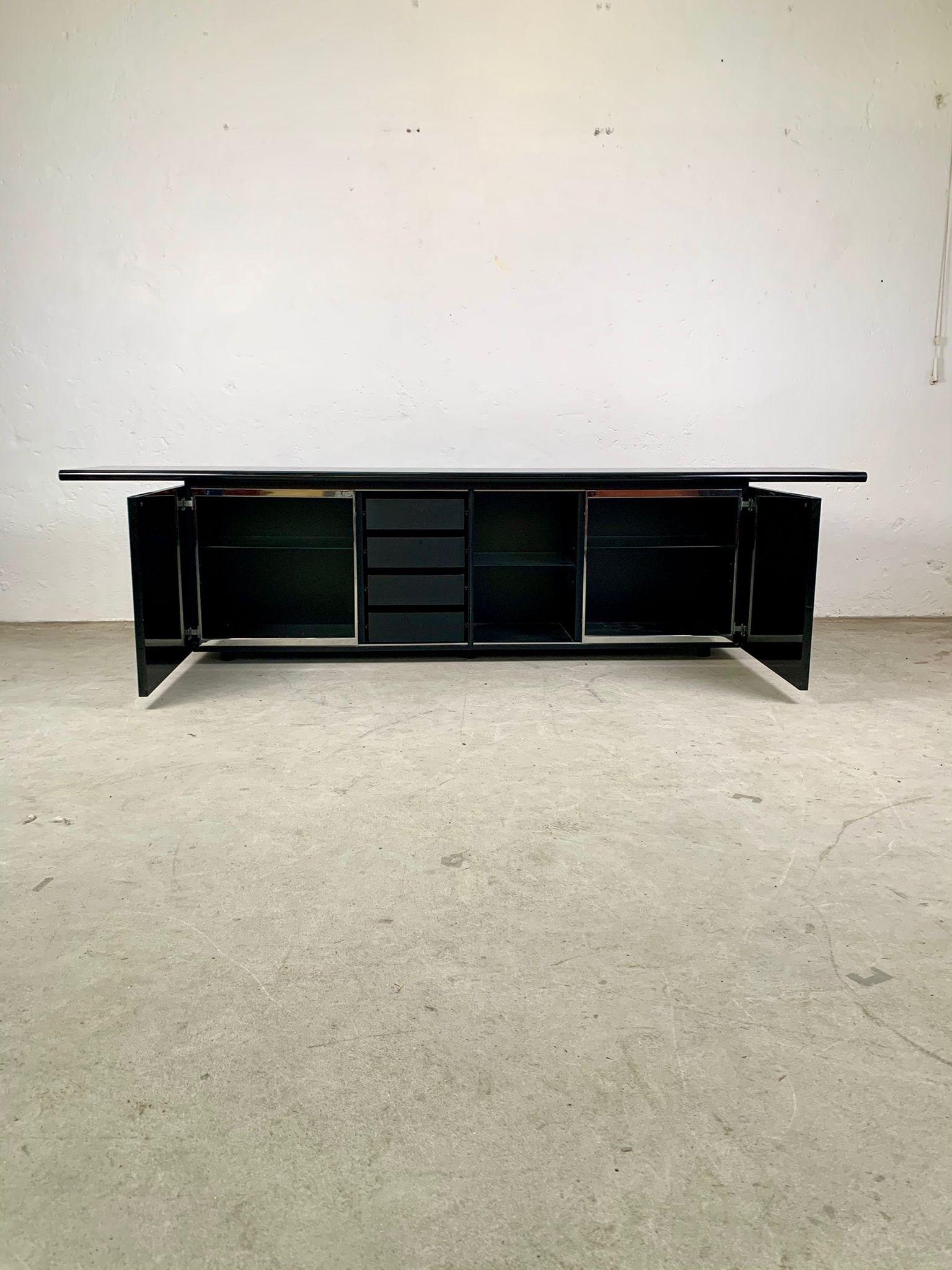 Giotto Stoppino and Ludovico Acerbis, Black lacquered two-door storage sideboard, 1977

Black lacquered two-door storage sideboard, there are drawers and shelves inside. 
Project winner of the compasso d'oro in 1979. 
