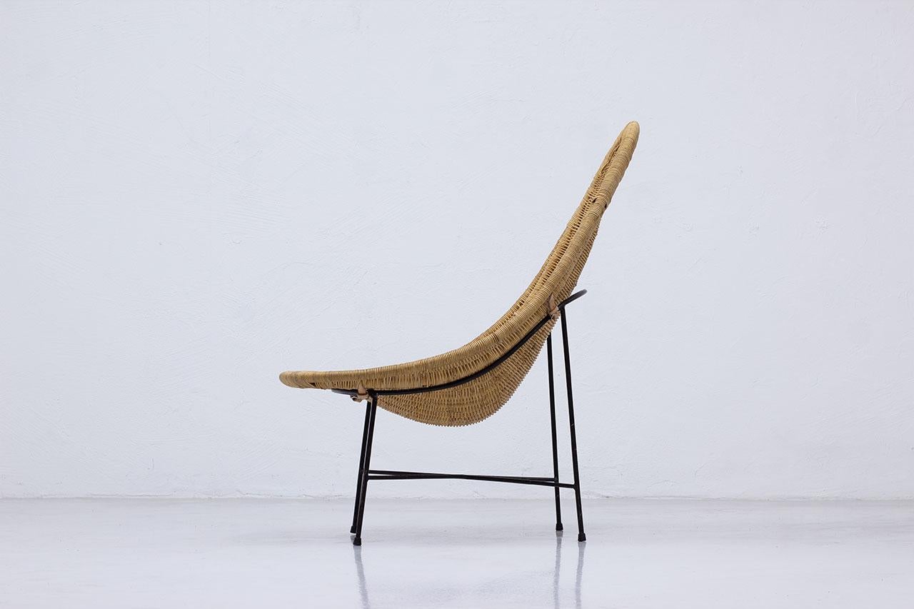 A design classic lounge chair model  “stora  Kraal” designed  by Kerstin  Hörlin-Holmqvist.  Manufactured by Nordiska  Kompaniet  (NK), in  Nyköping,
Sweden during the 1950s (Design in 1952, production during the 1950s). Made from cane with black