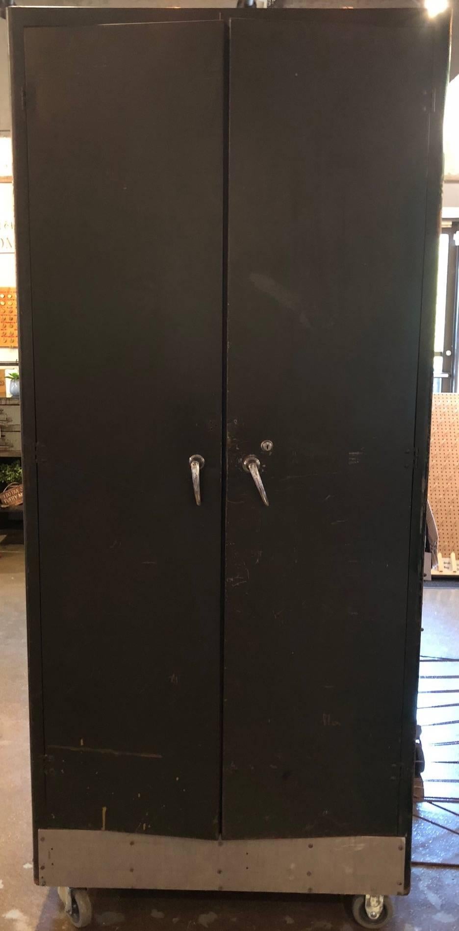 Storage locker / cabinet of steel on wheels divided into hanging closet and shelving for shoes, towels, hats and other clothing accessories. Industrial meets the functional home where storage is a major issue. Stands 7 feet tall. A walk-in closet on
