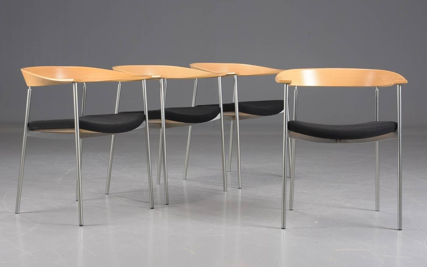 Set of four Johannes Foersom stackable armchairs designed in 1998 in tube steel, beech, chrome and black fabric made by Paustian.

The chairs feature elegant organic round shaped arm- and backrest in beech and frame in tube steel and chrome