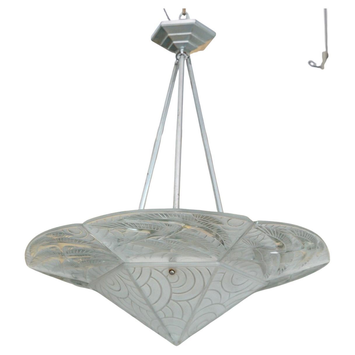 A Pierre D'Avesn Art Deco Frosted Glass Hanging Light
Circa 1930
Exquisite Fine French Art Deco Chandelier by Pierre D'Avesn
Hand blown relief frosted glass design with six glass plaques designed with stylized Art Deco storks in flight and bold