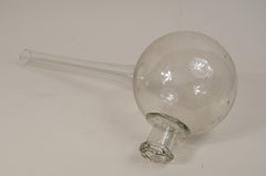 Transparent blown glass laboratory retort from the early 19th century.