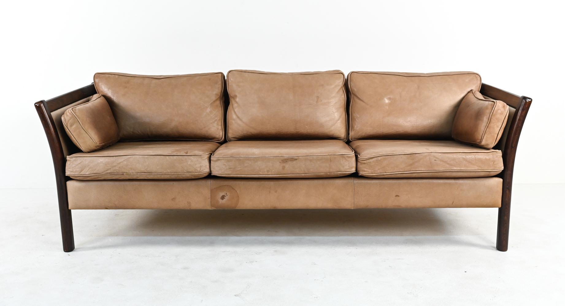 True to Stouby's continued quality craftsmanship and design, these Danish modern sofas combine comfort and style to be the perfect place for lounging. In handsomely patinated cappuccino leather with rich, warm stained beechwood frames, this matching