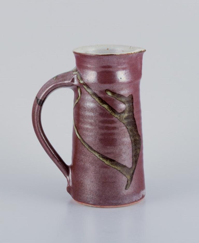Stouby Keramik, Denmark.
A handmade ceramic jug with glaze in brown and sandy tones.
1970s.
Signed Stouby.
In perfect condition.
Dimensions: Height 19.2 cm, Diameter 15.0 cm including handle.