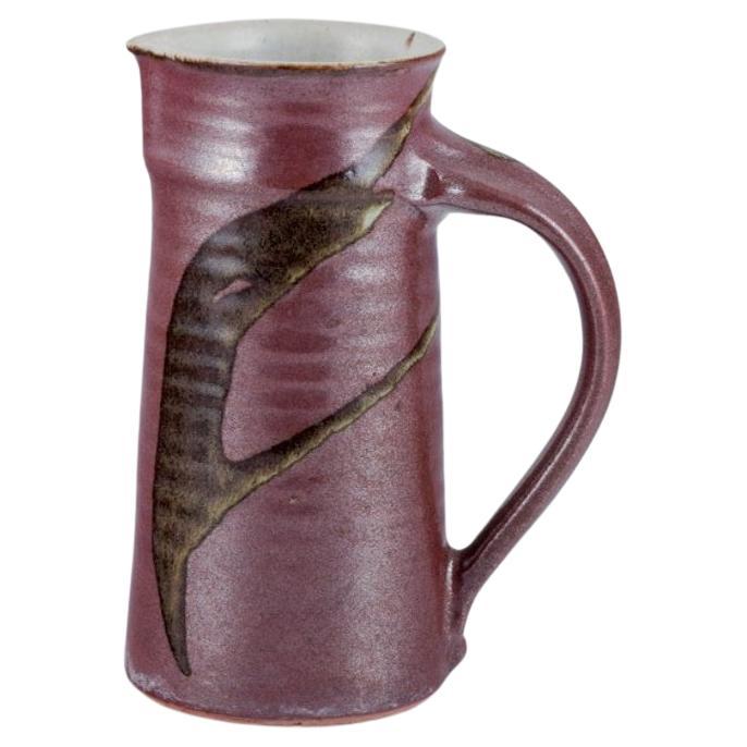 Stouby Keramik, Denmark. Ceramic jug with glaze in brown and sandy tones For Sale