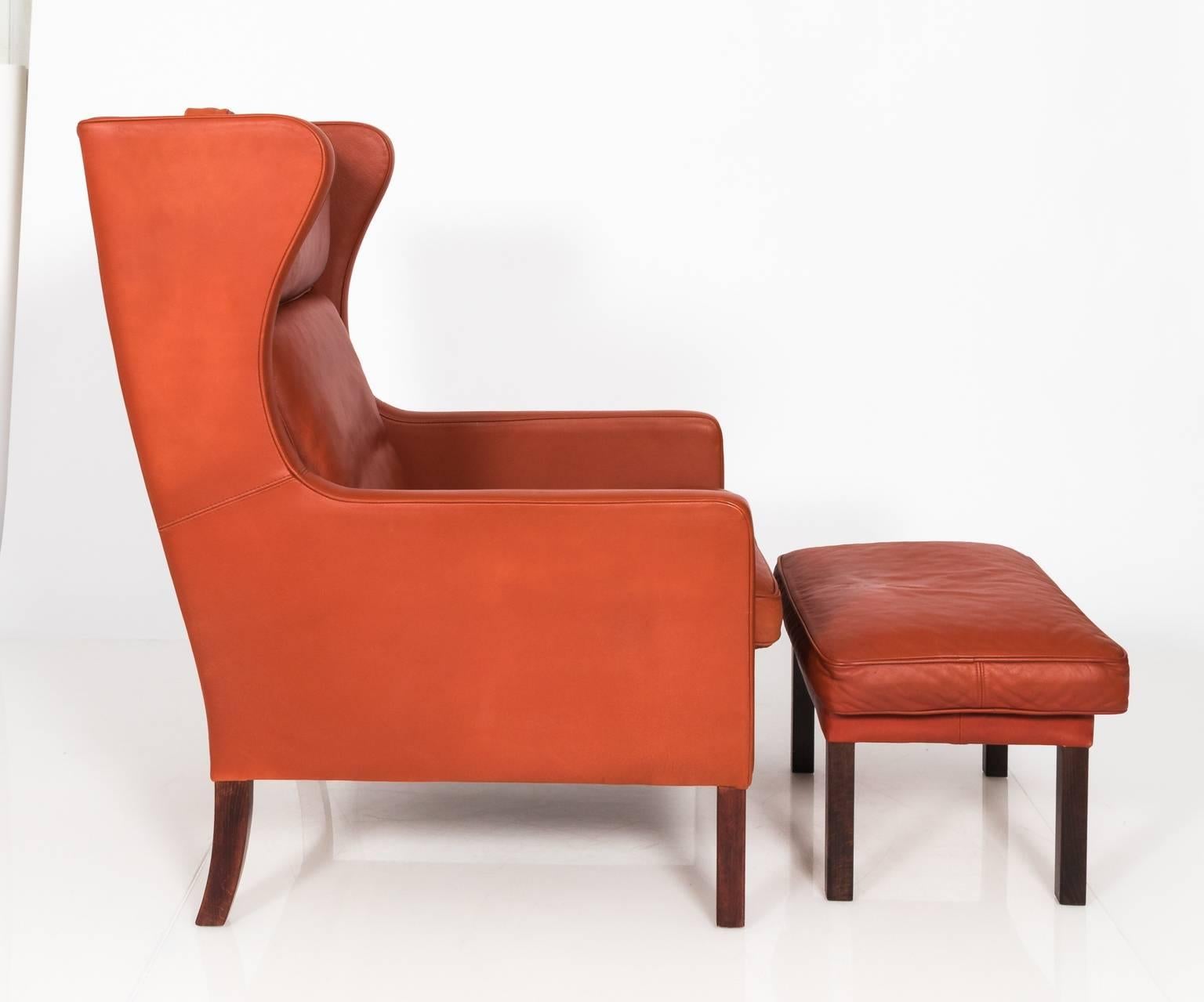 Danish Stouby Leather Wing Chair and Ottoman, Denmark, circa 1970s