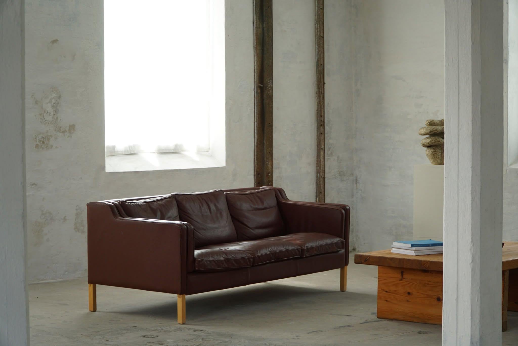 A classic Danish Mordern 3-seater sofa in brown leather, feets made in solid beech. Simple lines and a great comfort featured in this sofa. Designed by Stouby Møbelfabrik, Denmark. Made in the 1970s.

This beautiful sofa will complement many