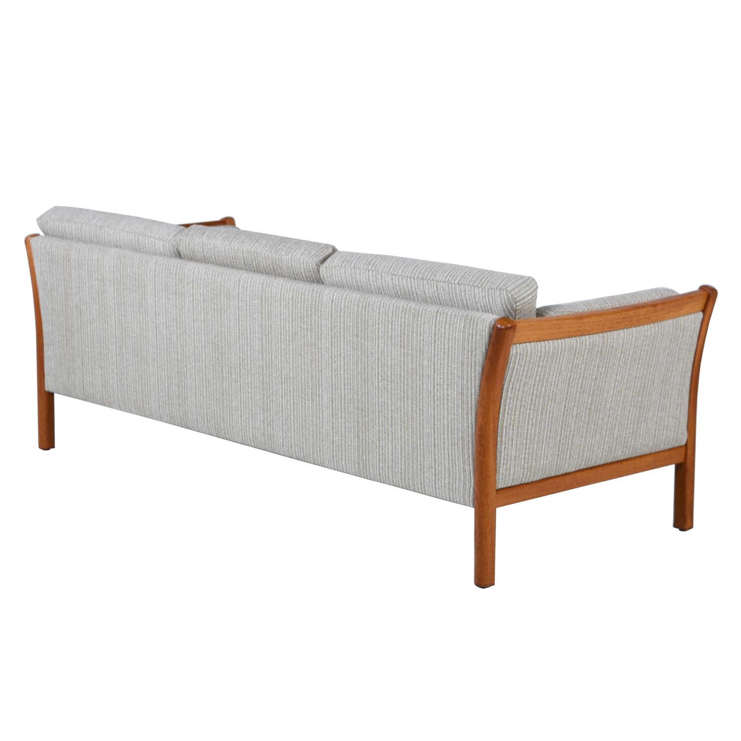 Super comfortable, fully restored, Danish modern teak Stouby sofa. Still doing business after over 100 years, Stouby’s Scandinavian quality rings true in the design of these chairs. Frames constructed of bent, teak wood. Masterfully engineered to
