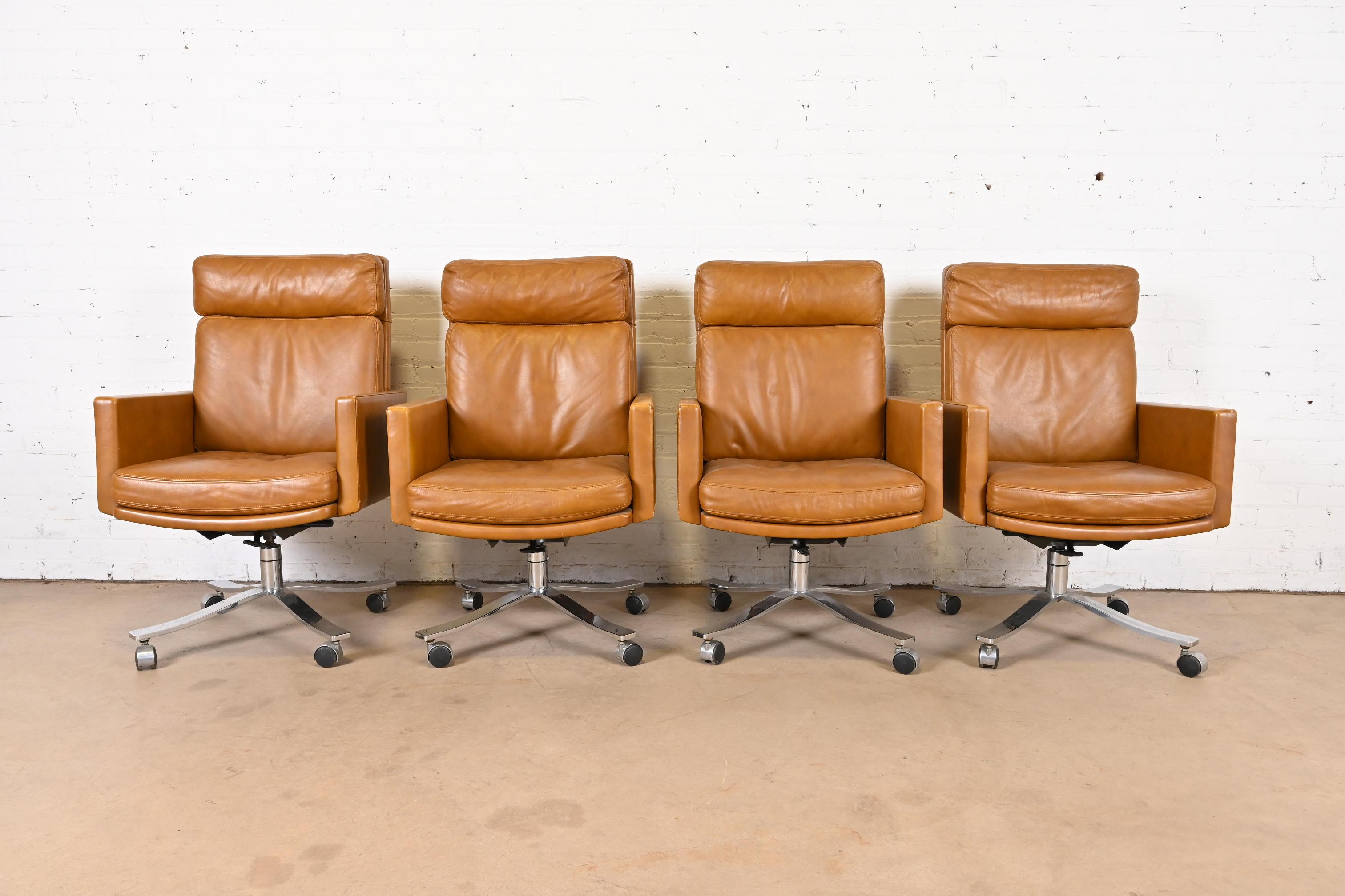 A beautiful and very comfortable set of four Mid-Century Modern executive leather swivel desk chairs

By Stow Davis

USA, Circa 1960s

Gorgeous brown leather upholstery, with chrome base, and black casters.

Measures: 28.5