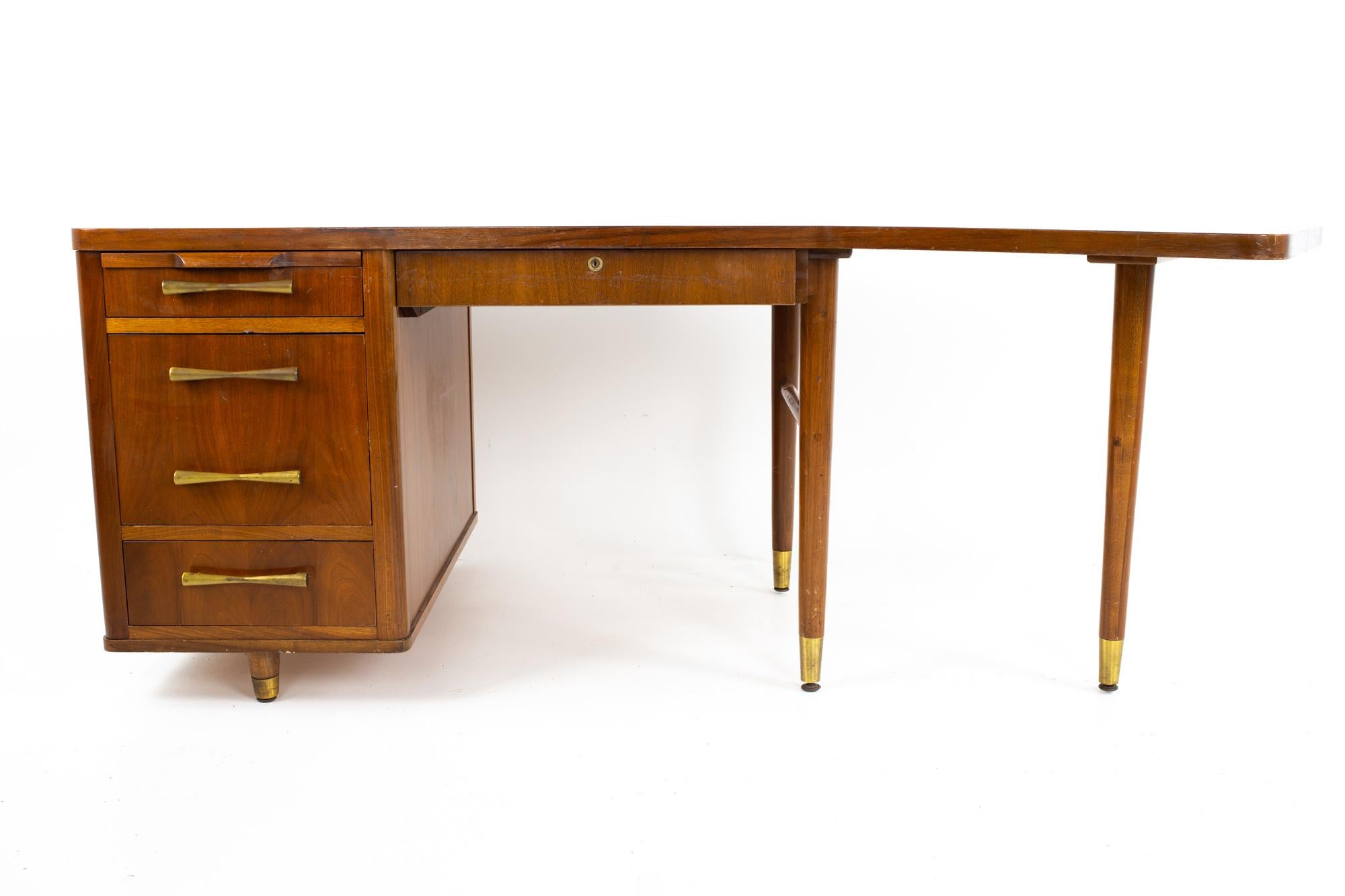Stow Davis mid century walnut and brass boomerang desk

Desk measures: 80 wide x 35.5 deep x 29 inches high with a chair clearance of 27.75 inches

All pieces of furniture can be had in what we call restored vintage condition. That means the