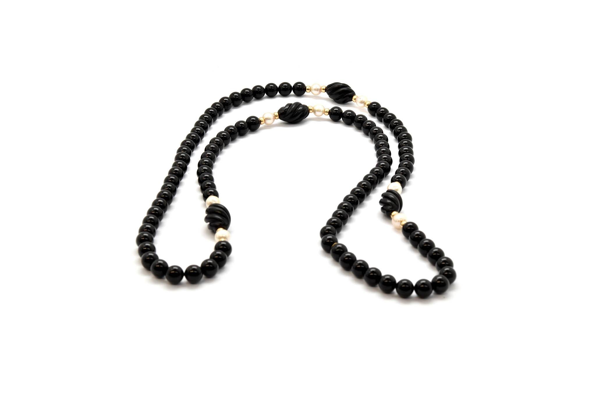 This is a beautiful 34” inch strand of black onyx beads with 14k yellow gold bead and pearl accents! There are sixteen 14k yellow gold bead accents, stationed between each accent, are 7mm freshwater pearl beads. In between the yellow gold and pearl