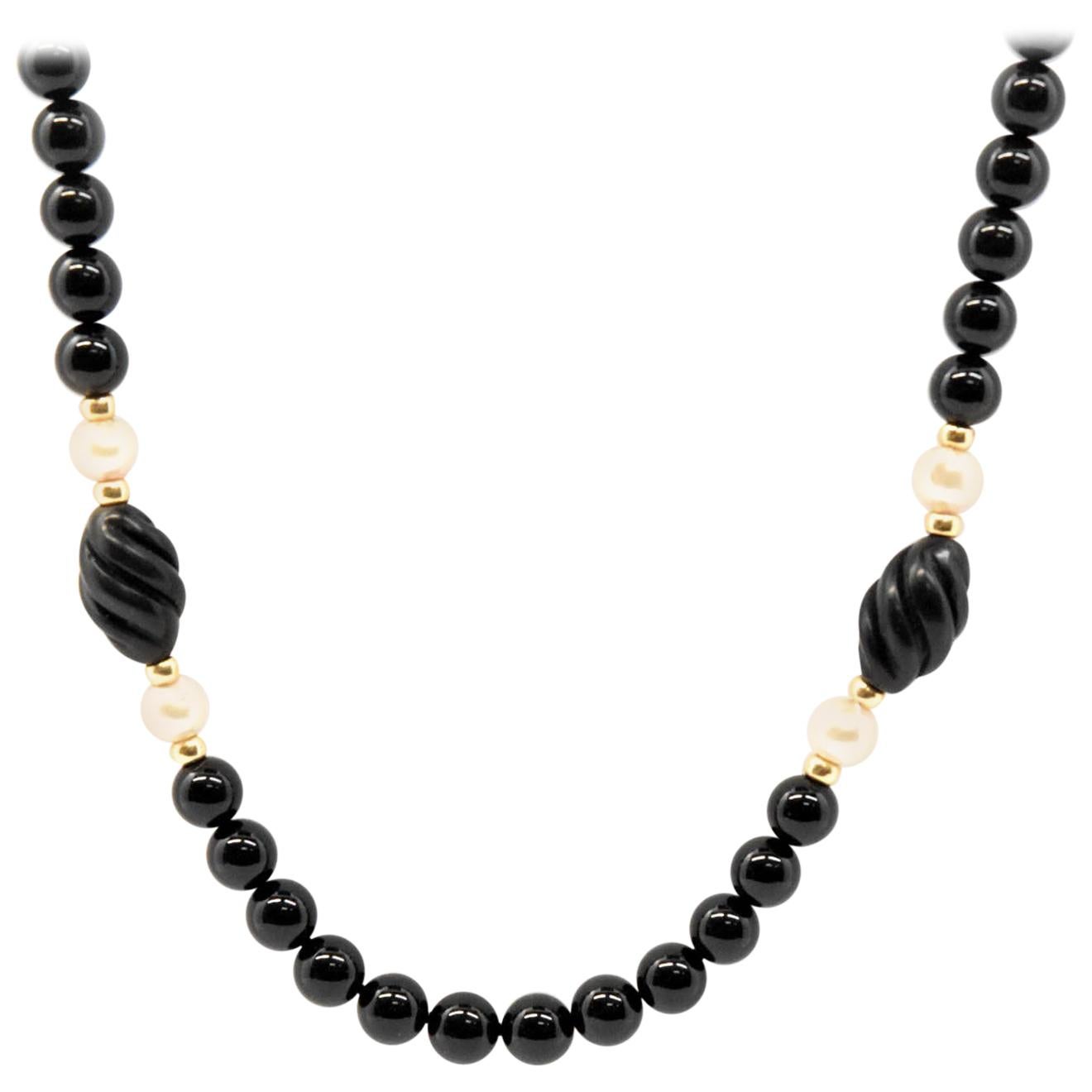 Strand of Black Onyx Beads with 14 Karat Yellow Gold and Pearl Accent Beads