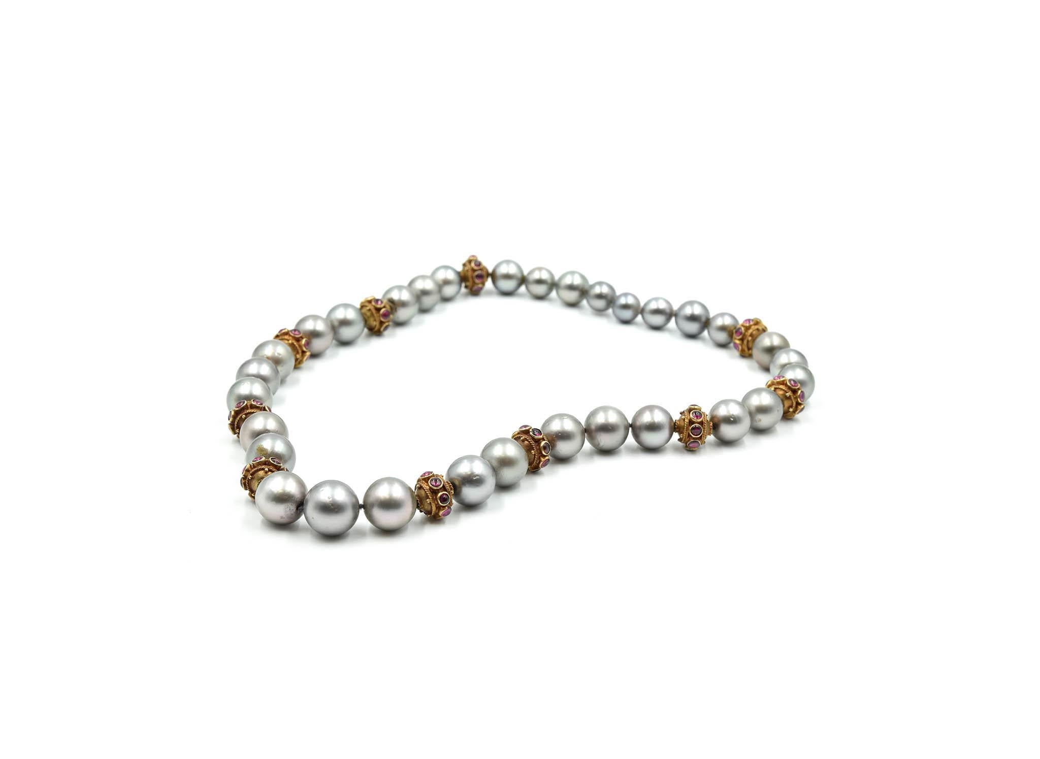 This is a great combination of black Tahitian south sea pearls with 14k yellow gold accents set with cabochon rubies! The black Tahitian south sea pearls measure between 8.09mm-11.27mm. Each south sea pearl is black with a silver glossy overtone.