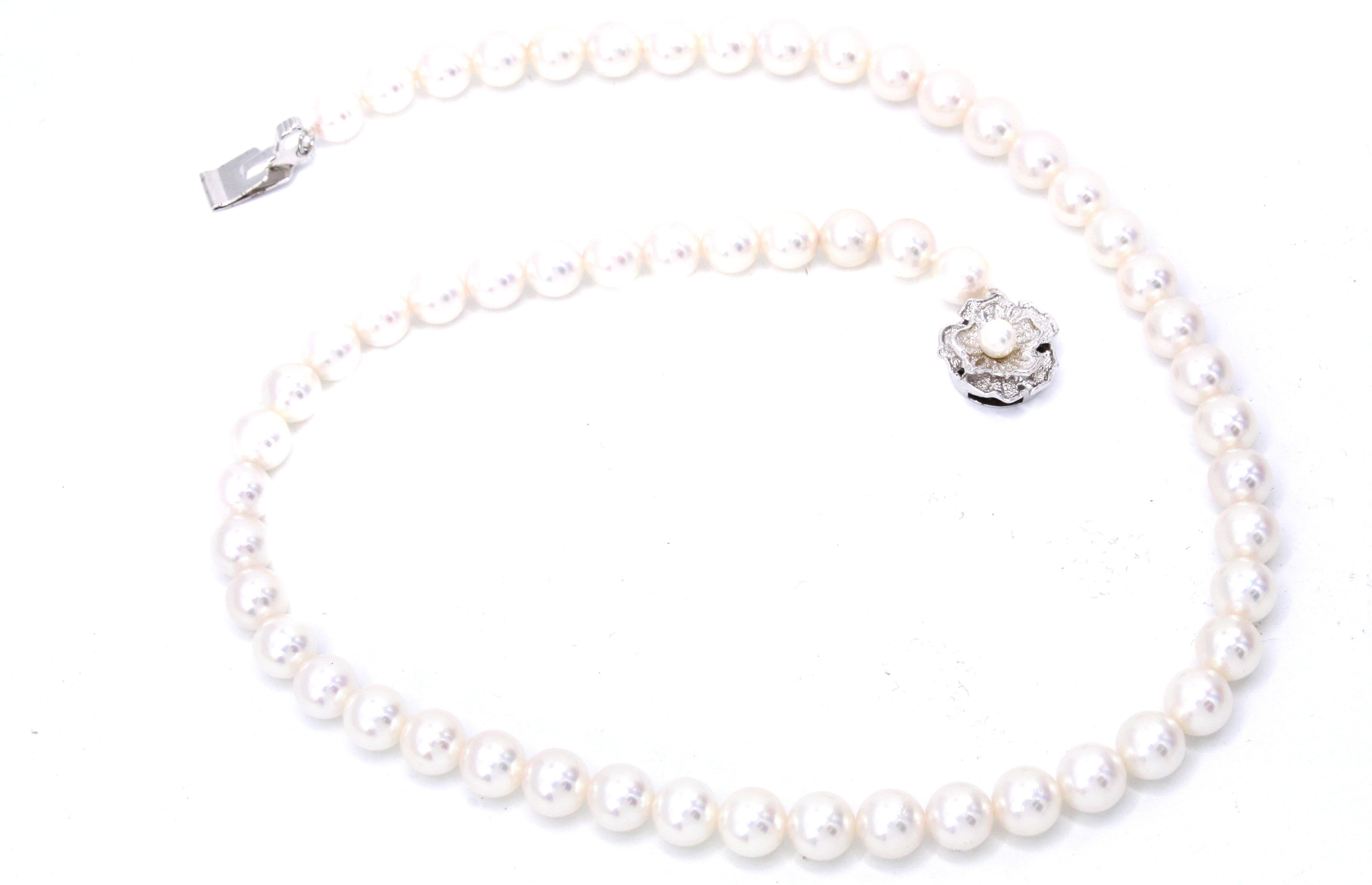 Strand of 57 fine Akoya cultured salt-water pearls ranging from 7 to 7.45 millimeters in diameter. The pearls have an amazing luster and are without any eye visible blemishes. This strand is 16.5 inches long and has a polished silver floral closure. 
