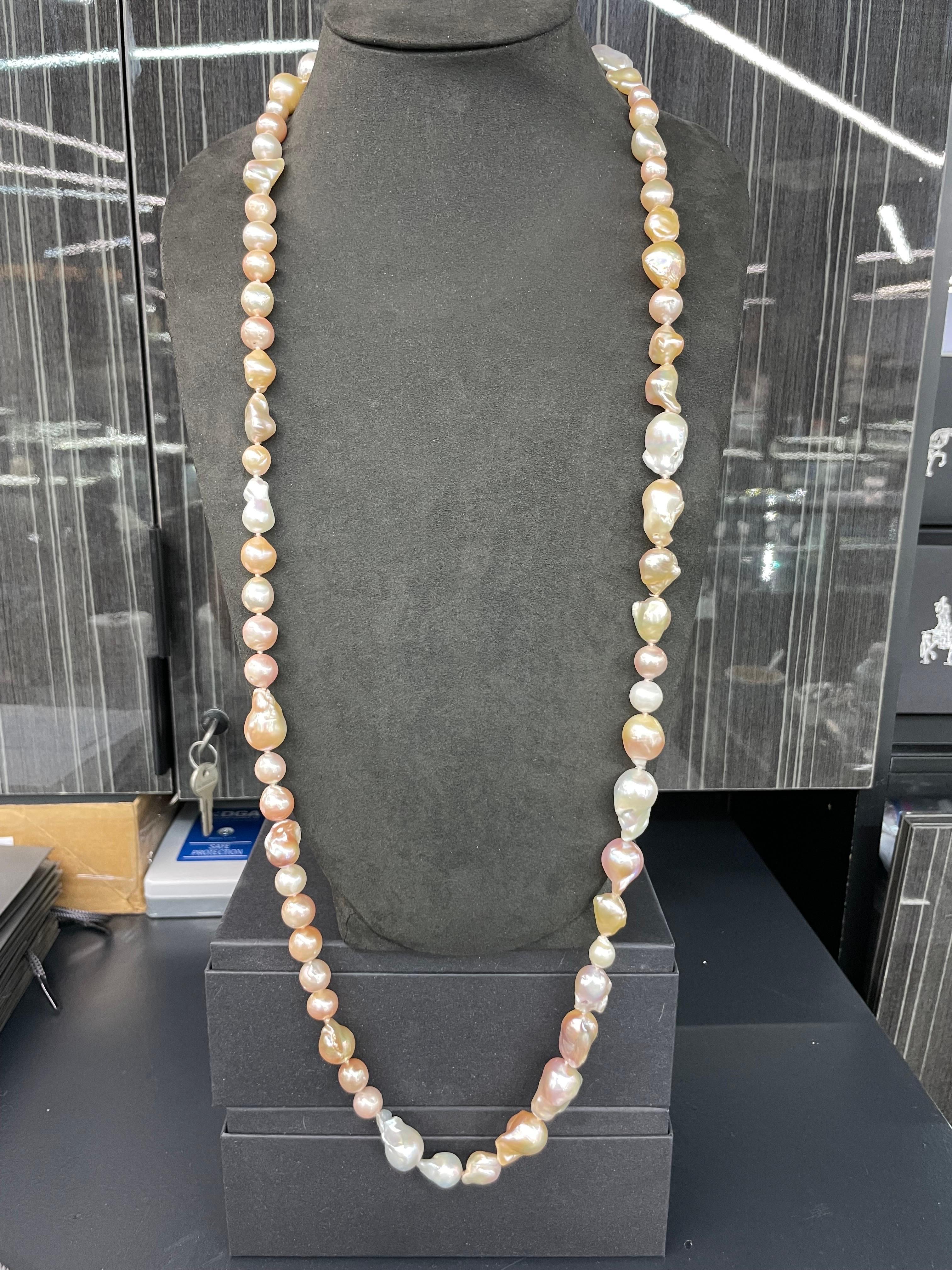 A strand of lovely white and pink Baroque pearls measuring 9-25 MM, 42 inches long. Can be made as a double strand on neck. 
