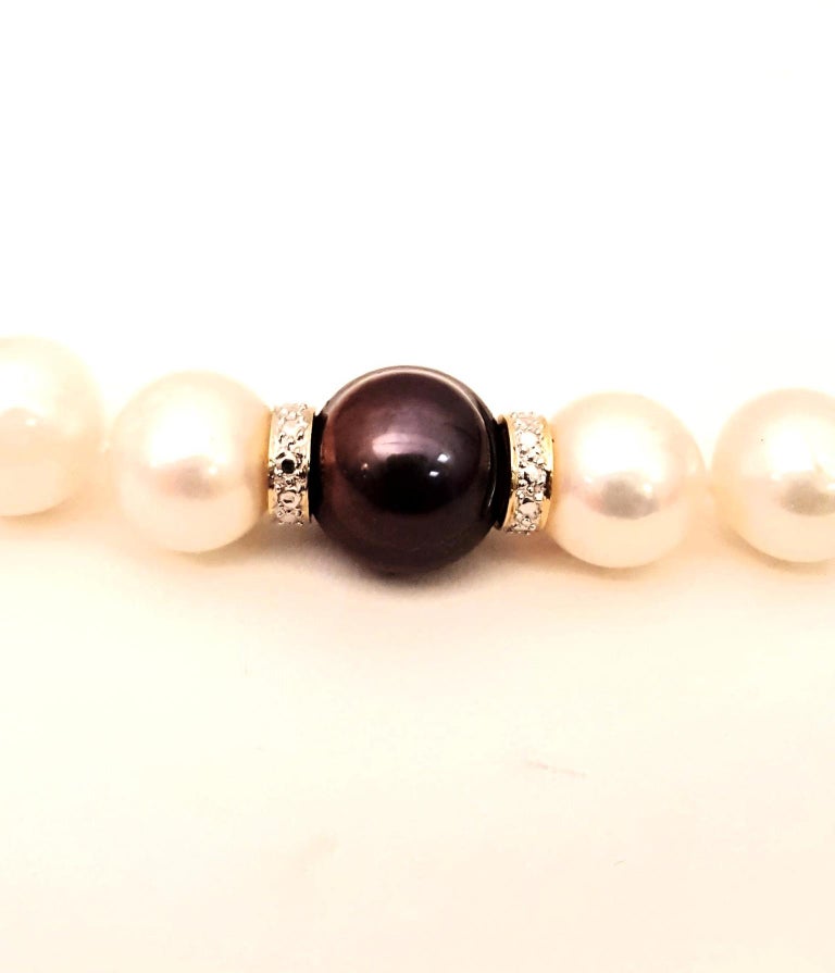 Strand of White Pearls One Black Pearl and Diamond Spacers Necklace w
