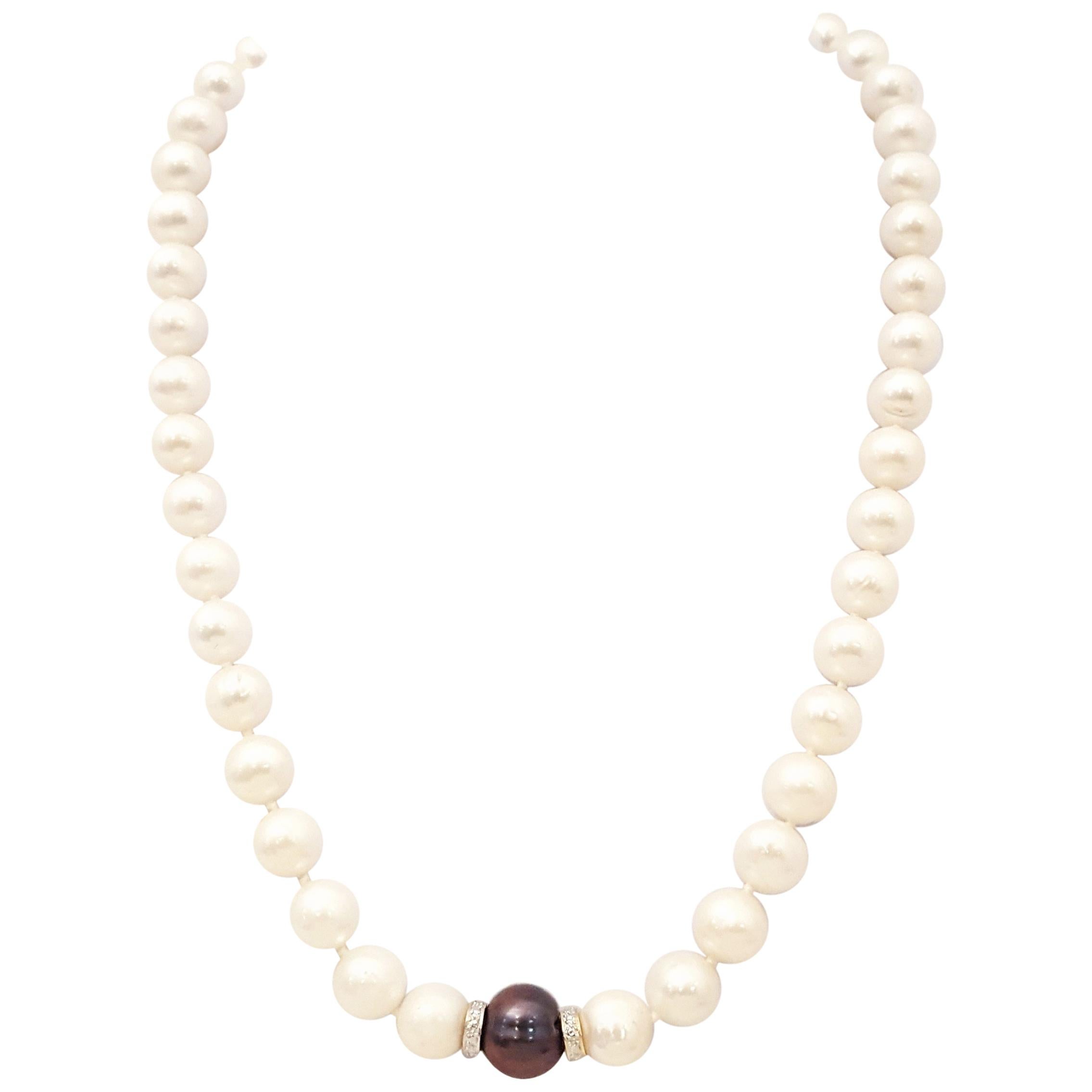 Strand of White Pearls One Black Pearl and Diamond Spacers Necklace w 14 K Clasp For Sale
