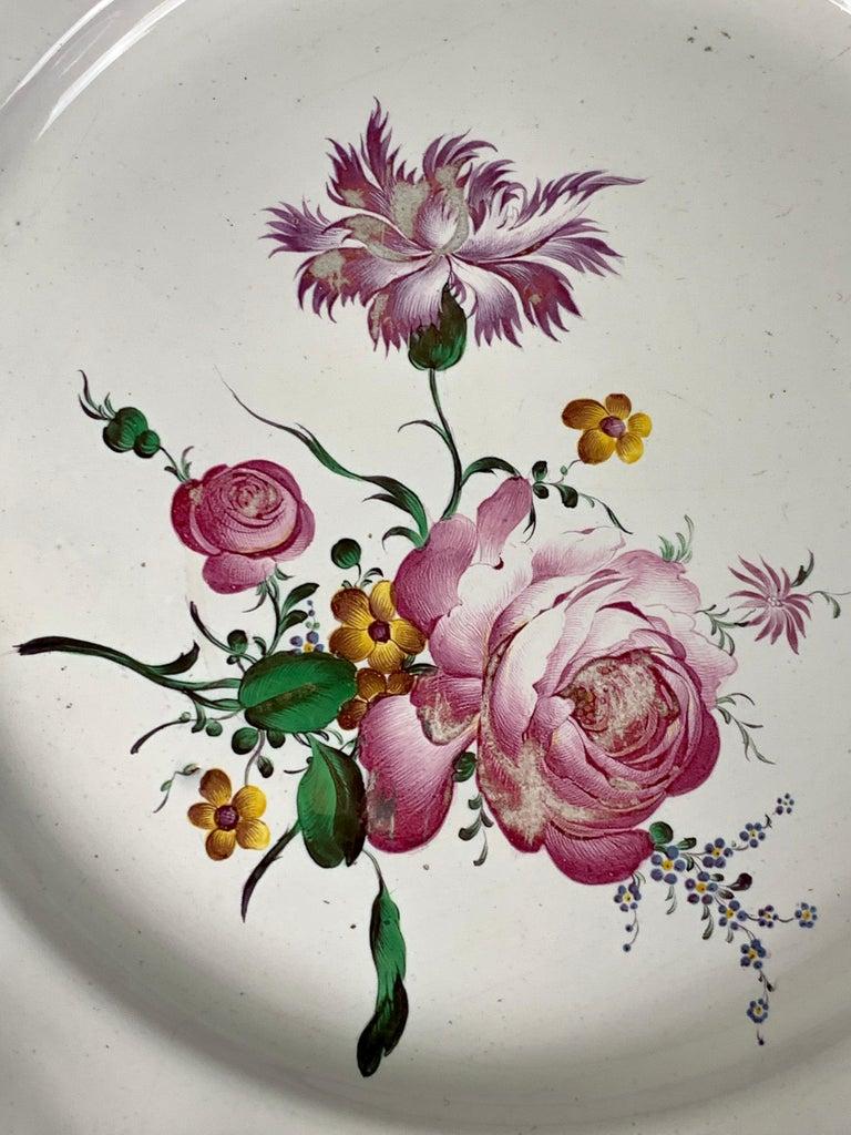 This 18th-century faience dish was hand-painted in the factory of Paul Hannong in Strasbourg, France. The flowers are exquisite.
I would almost call them delicious! 
Paul Hannong, and his brother Joseph, were known for the fabulous flower painting