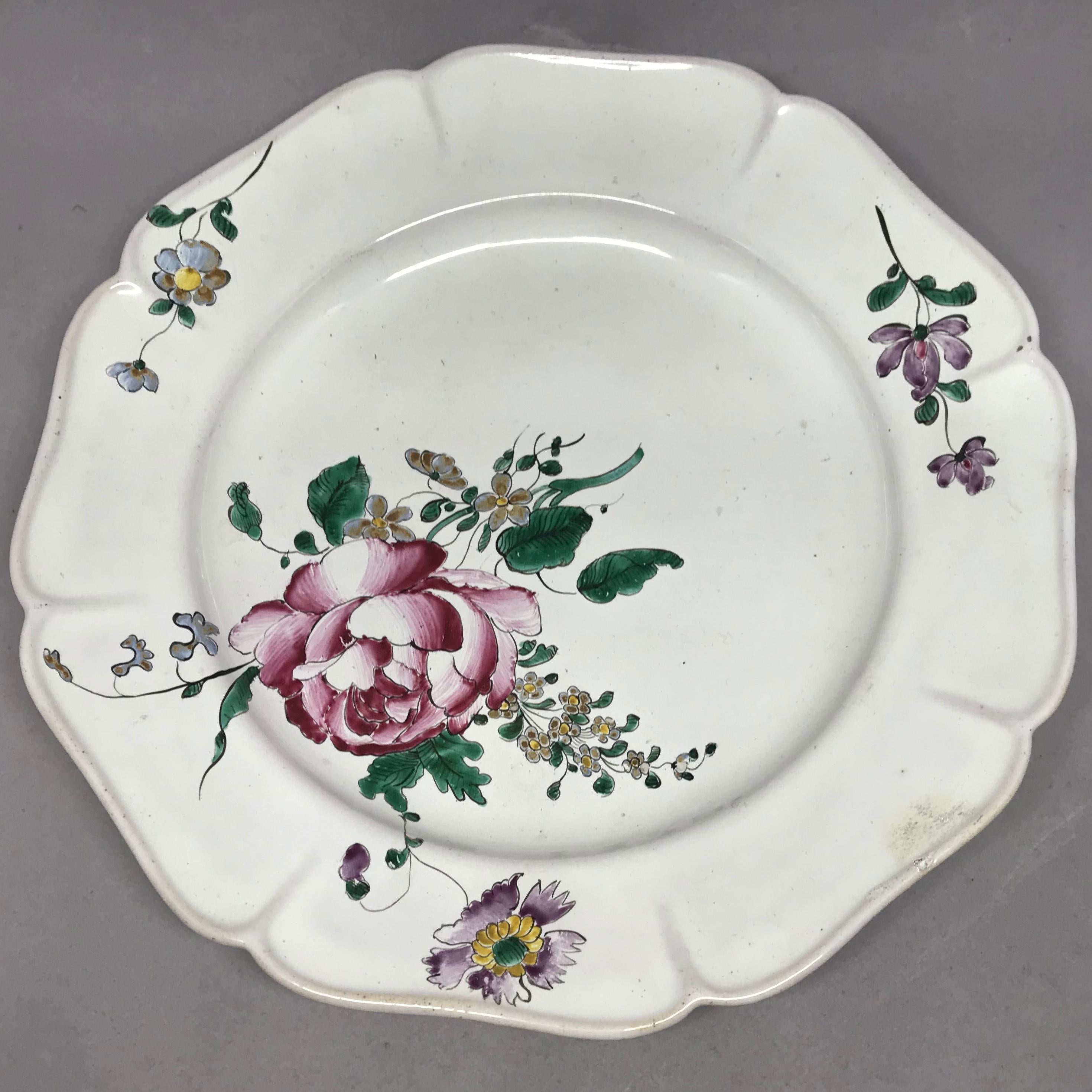 Strasbourg faience floral plate. Antique faience plate with large floral bouquets and lobed rims with further floral sprays and insects; with blue underglaze markings for Hannong Factory, France, circa 1750. 
Dimension: 9