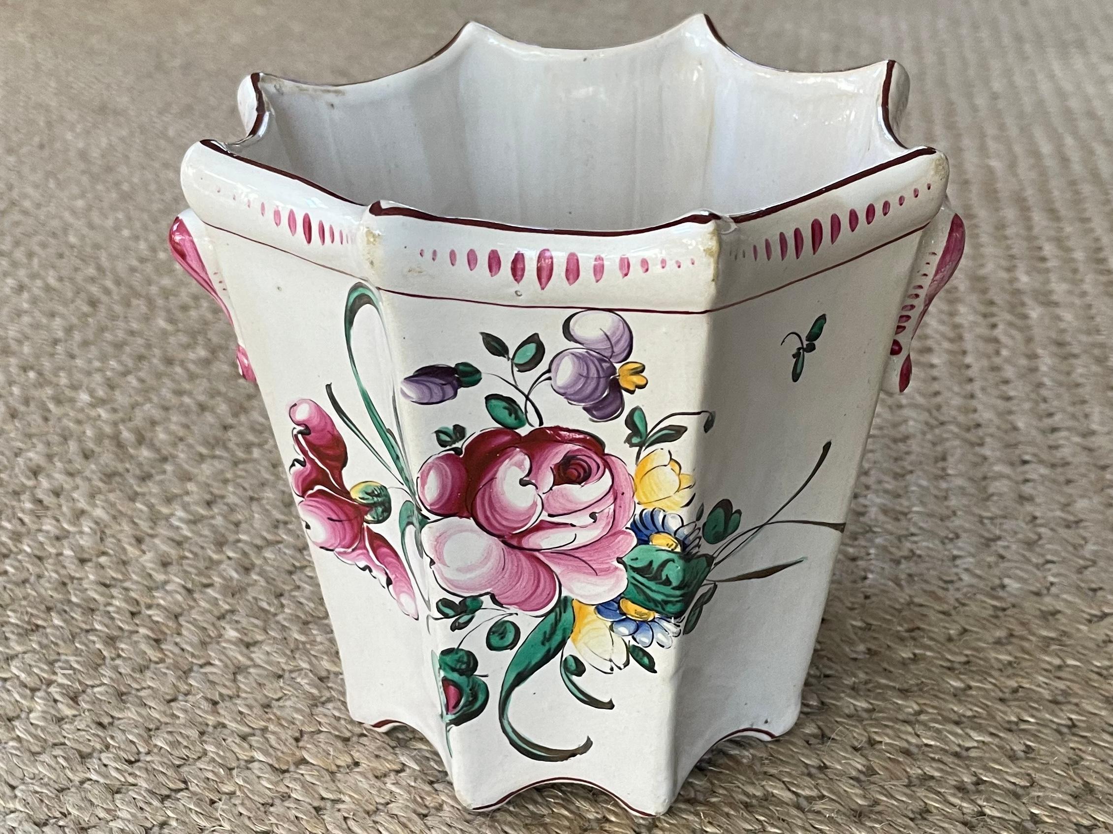 Strasbourg floral cachepot. Flared octagonal cream faience pot with pink, magenta, purple and yellow Strasbourg style floral painted sprays and characteristic decoration with  opposing handles. Vintage faience cachepot flowerpot marked Made in