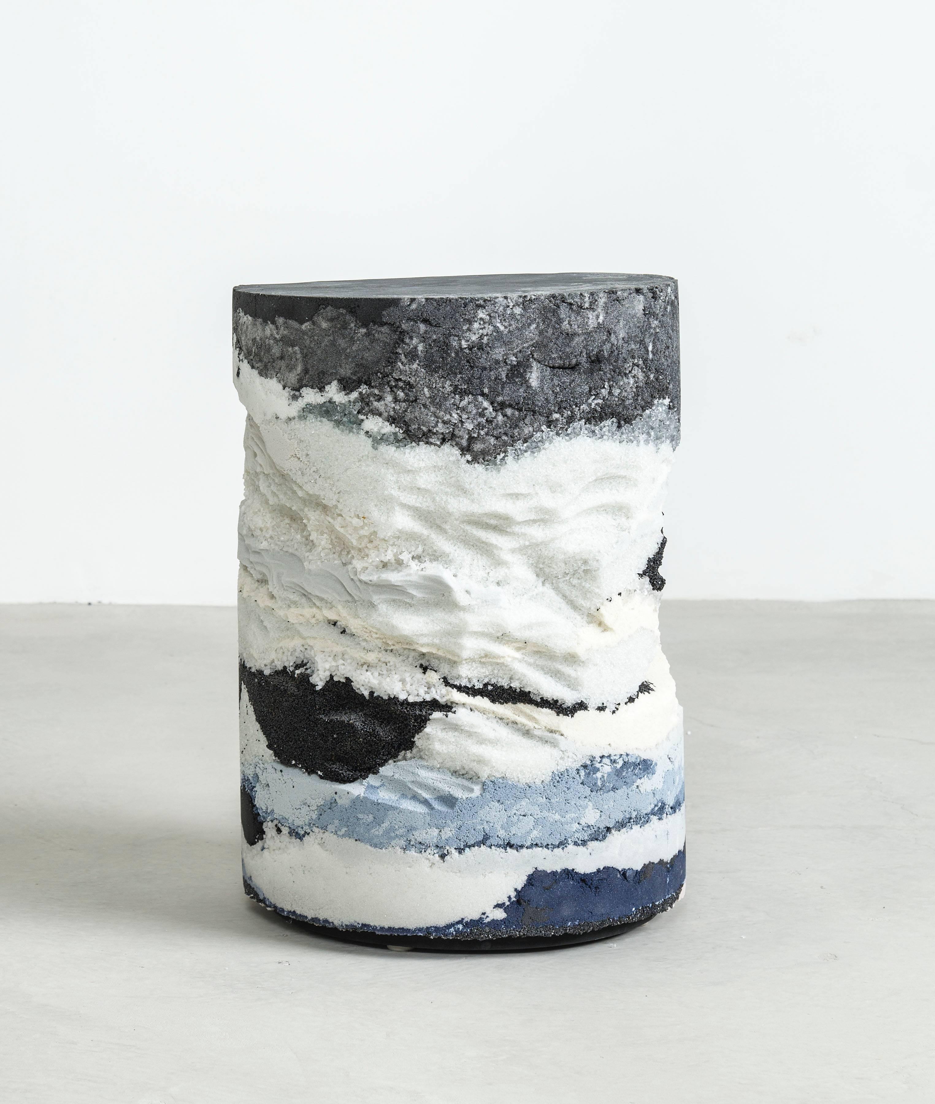 Inspired by the layers of the earth, the made-to-order drum is solid and cast from hand-dyed black silica, crushed glass, powdered glass, crystal quartz and sand. Packed in layers, the raw edges are hand-carved in natural undulations to create an