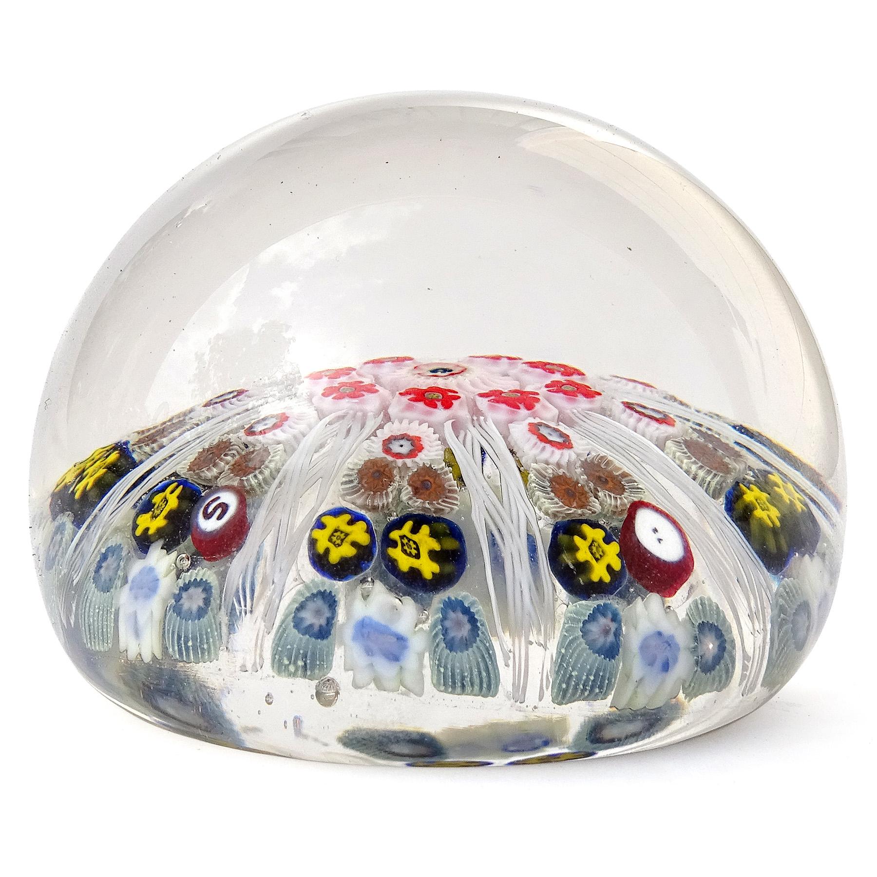 Beautiful vintage Strathearn hand blown millefiori flowers, white ribbons, hand made in Scotland art glass paperweight. It has 2 added murrines, one with the letter 