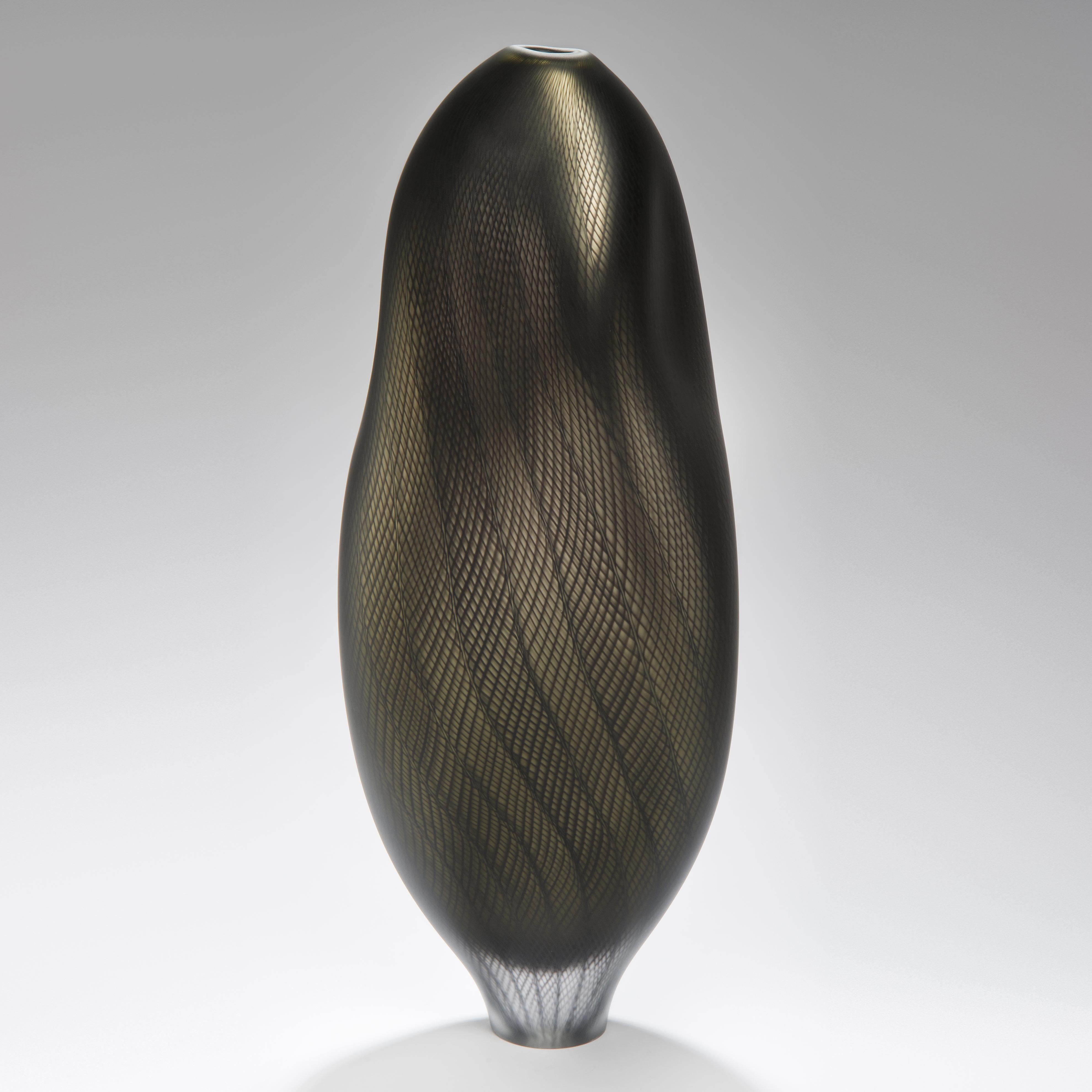 Stratiform Aes Zanfirico 001 is a unique hand blown glass vessel with fine filigree cane detail created by the British artist Liam Reeves. hand blown in bronze and black coloured glass, the interior has a mirrored finish, which results in a