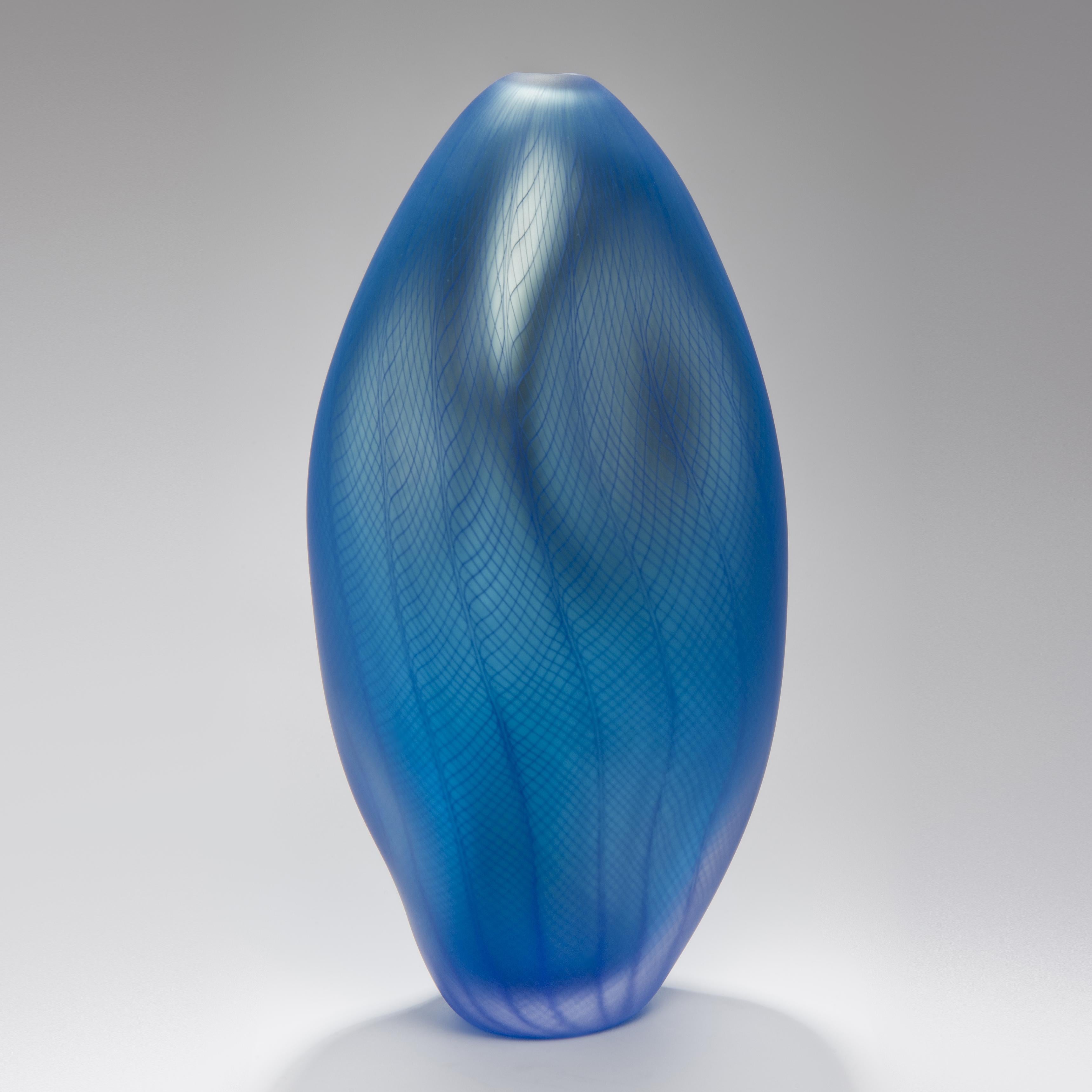 Stratiform Caeruleus 1.0.001 is a unique handblown glass vessel with fine filigree cane detail created by the British artist Liam Reeves. Handblown in aquamarine and turquoise blue coloured glass, the interior has a mirrored finish, which results in
