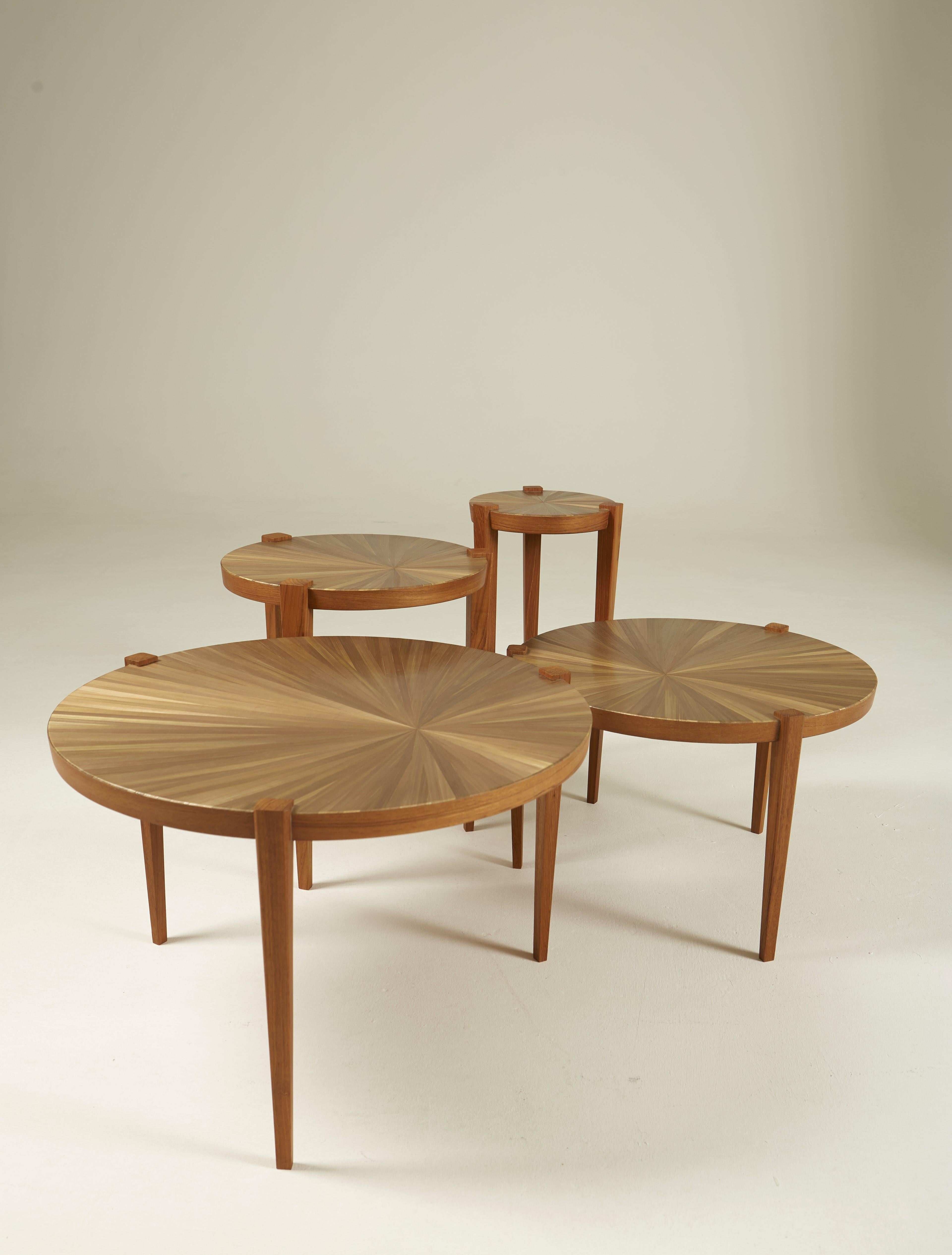 Set of 4 side tables in solid teak and teak veneer, tops inlaid with straw with a sun motif. Variable dimensions. Exceptional furniture - unique pieces.