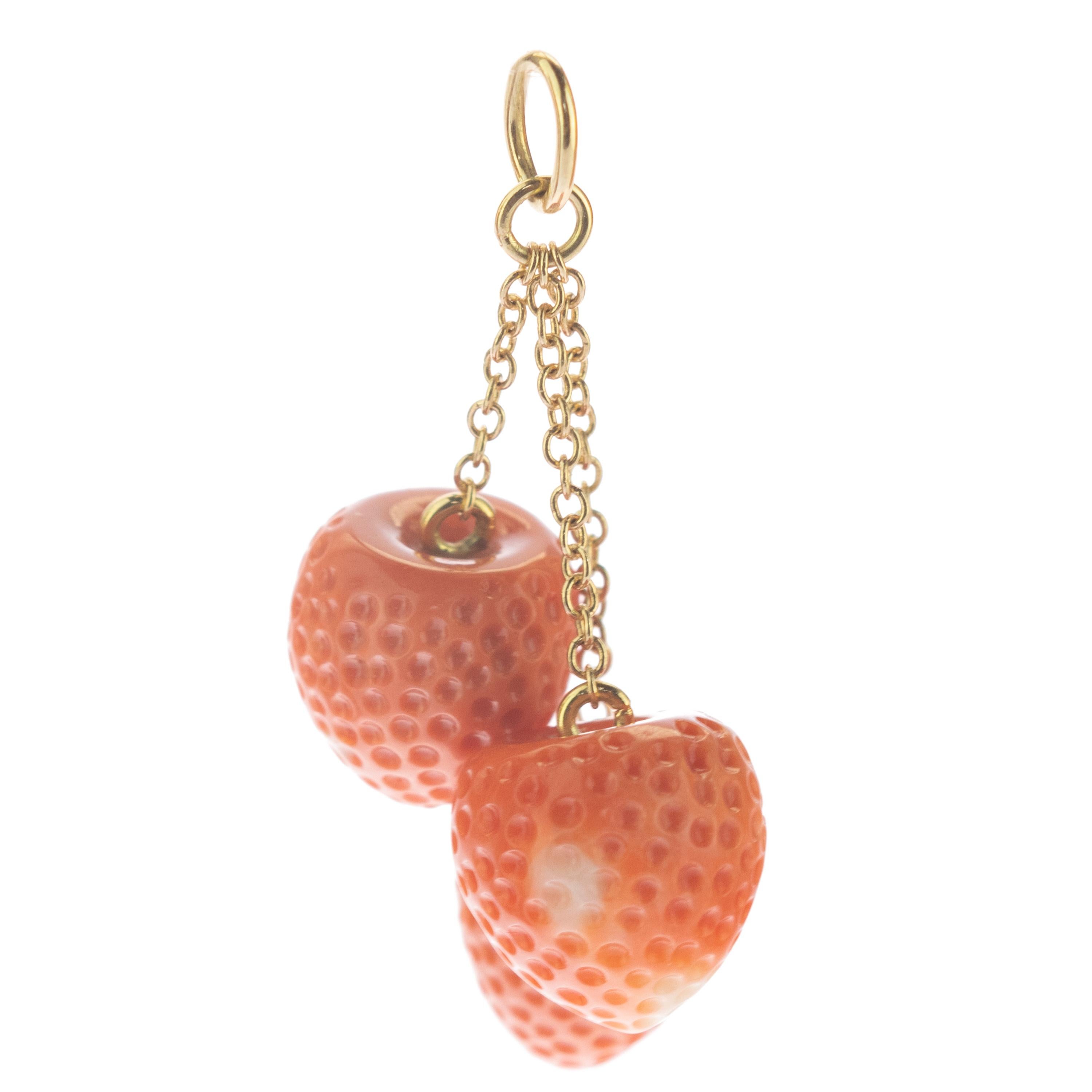 Astonishing and sweet mediterranean strawberry coral pendant . Natural coral carved gems holded by two 18 karat yellow gold chains that evoke the italian handmade traditional jewelry work Drop and dangle pendant with a subtle movement for a perfect