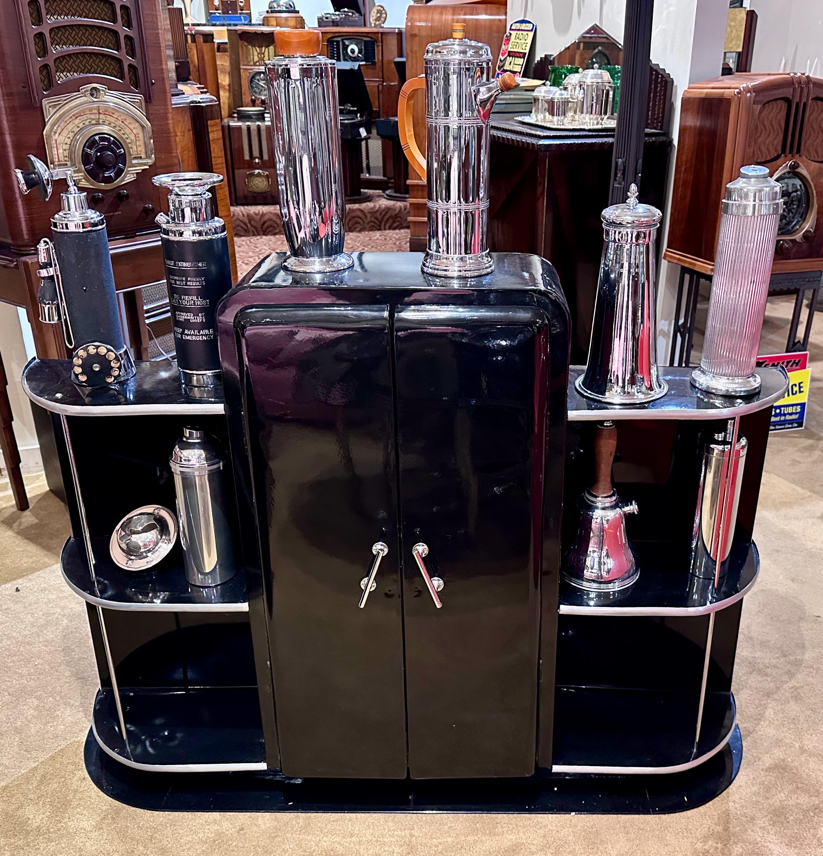 Streamline Art Deco Bar Cabinet  in metal  with chrome details has sleek lines, geometric shapes, and a polished, reflective surface characteristic of Art Deco design. As a bar cabinet, it can store and display barware, liquor bottles, and other