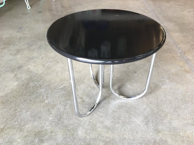 Streamline Art Deco coffee table manufactured by Royal Chrome. The table features chromed U-shaped tubular legs with a sleek black lacquer tabletop.