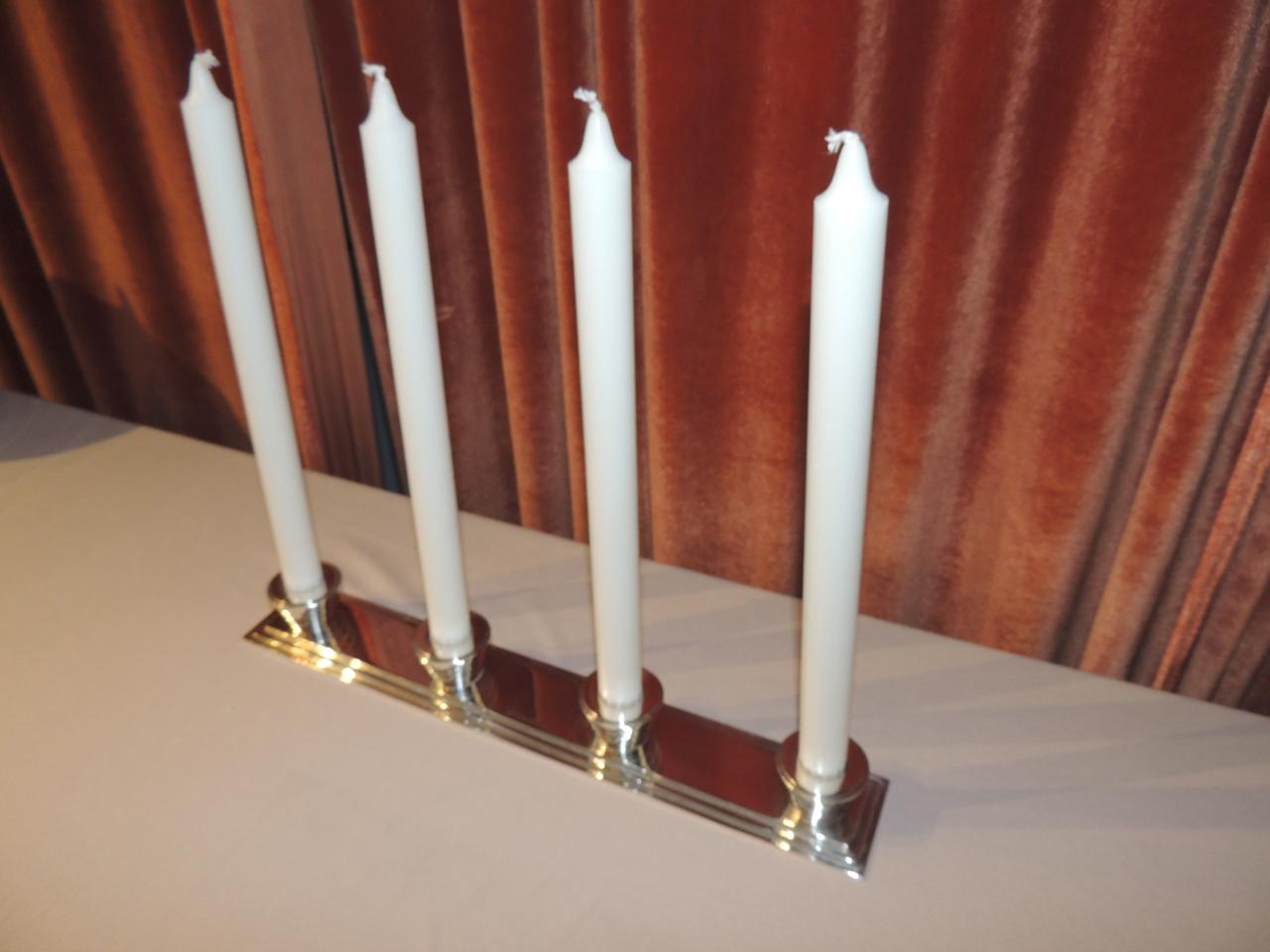 A streamlined silver candelabra elegant in its simplicity and designed by Luc Lanel for the renowned company Christofle.

Silver plating over bronze makes this exceptionally weighted and substantial. The decorative element is a series of stepped