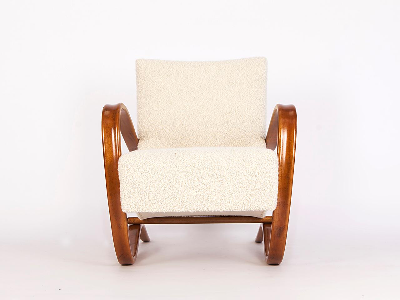 This lounge chair by Jindrich Halabala for Spojene UP Zavody was produced during the 1930s. The armchair will be restored to order with a new spring. The wooden parts restored. Covered with an Italian fabric made of soft wool and alpaca by Dedar.