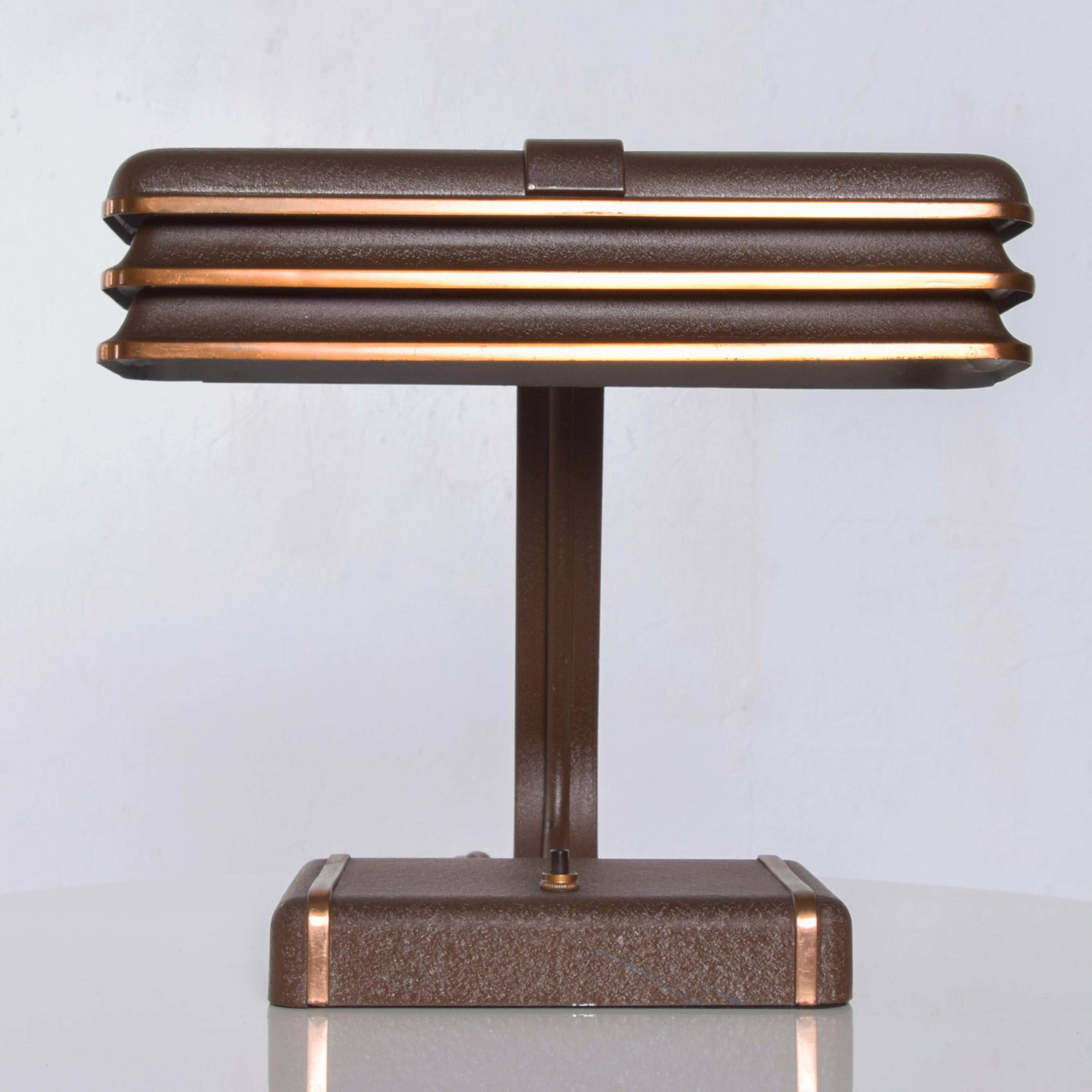 Streamline Industrial modern Art Deco metal table desk lamp attributed to the style of Donald Deskey, circa 1930.
Crafted in metal with brown power coat finish and copper plating.
Measures: 11