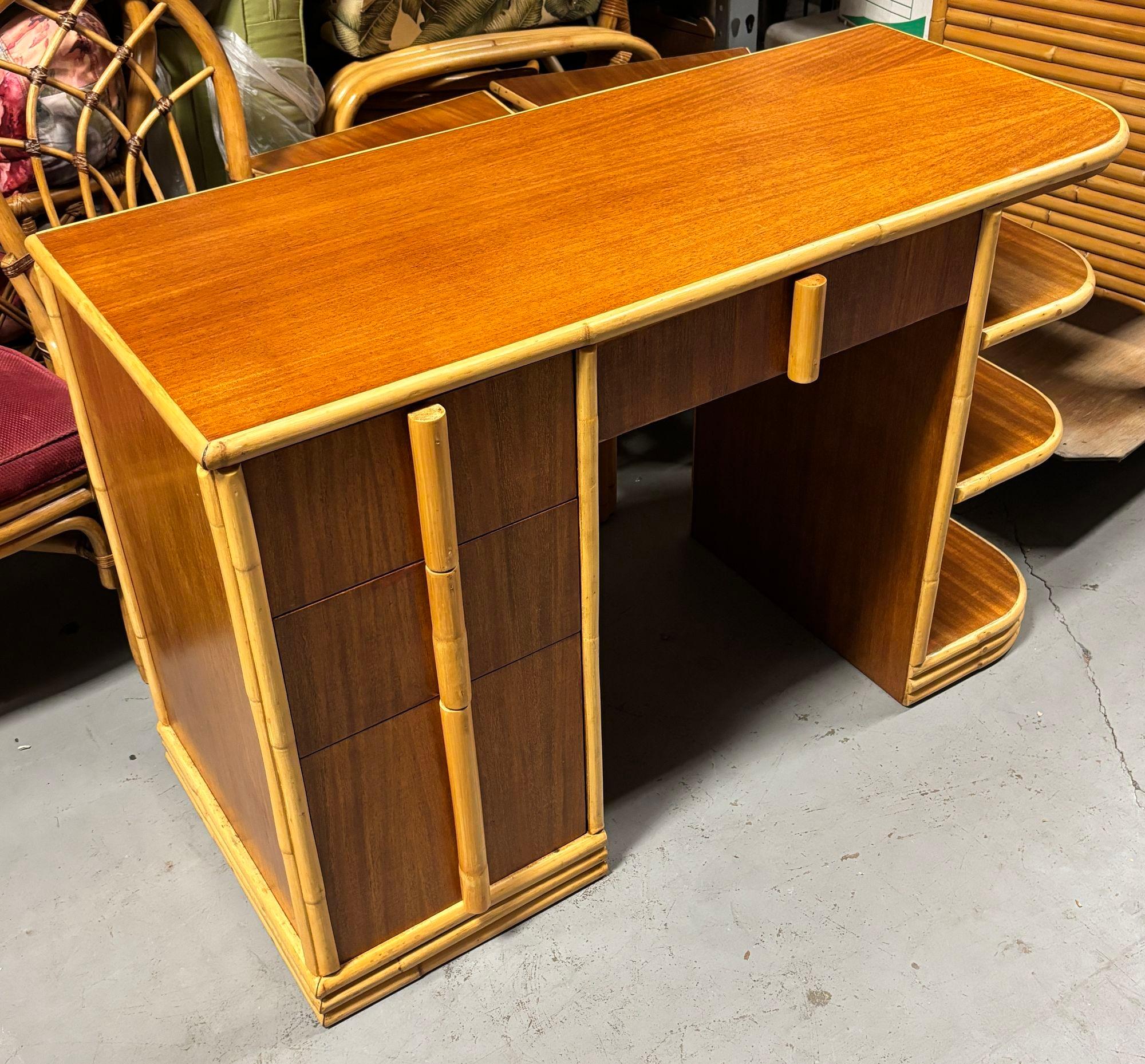 Streamline Art Deco rattan writing desk with a rattan border, Mahogany sides, and top with four pull drawers and 3-tier side shelf along the side. 

Restored to new for you.

Tropical Sun Rattan was started in 1934 at 117 West Colorado Blvd in
