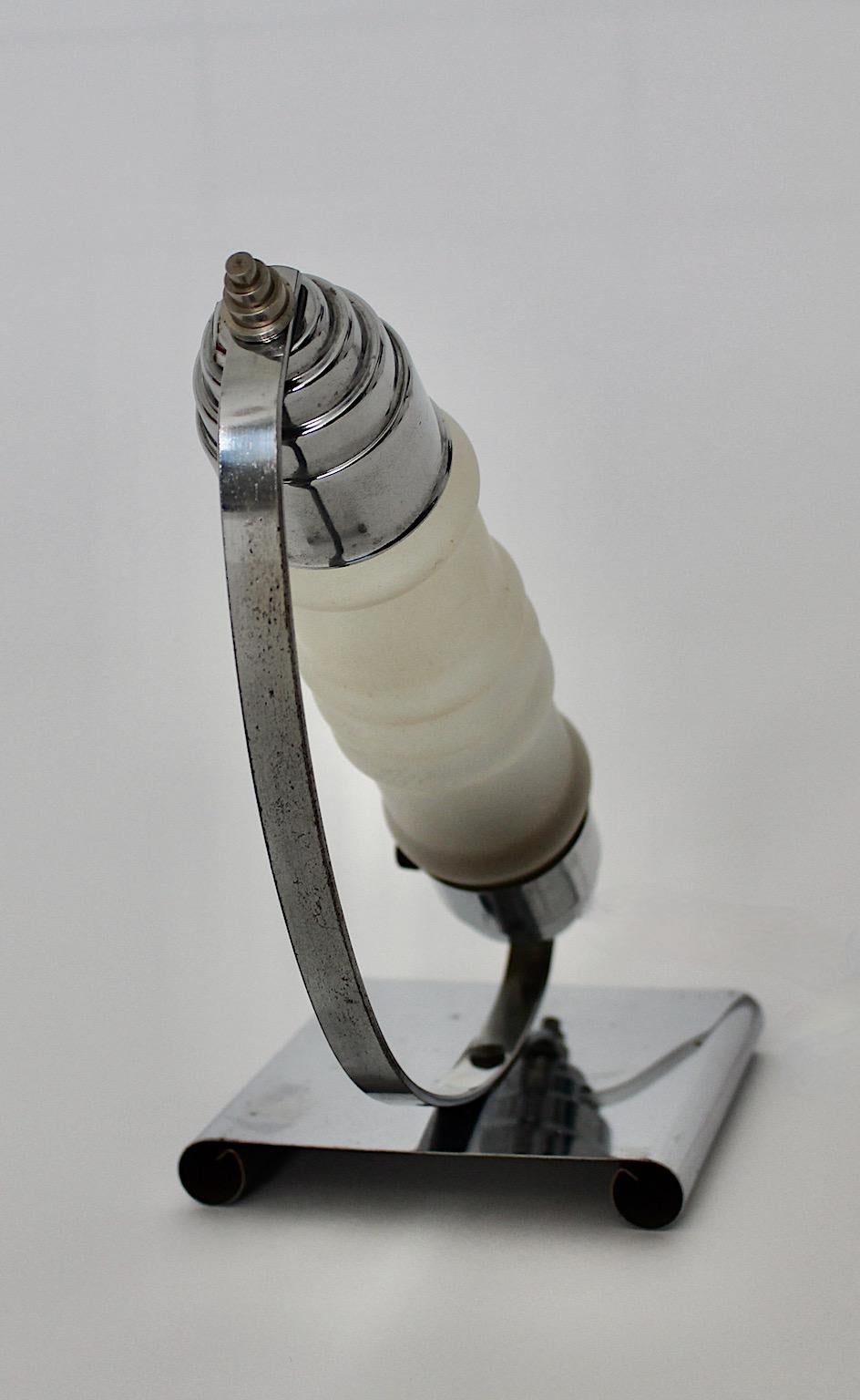Streamline Moderne vintage table lamp from chromed metal and wavy milk glass designed and manufactured 1930s Czech Republic.
The table lamp shows no damage and is in original condition. The main cable was changed few years ago.
Sleekness and