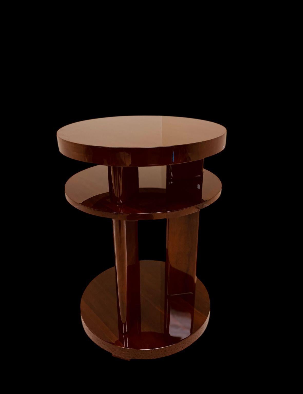  Elegant Art Deco side table reminiscent of the works by Donald Deskey or Gilbert Rohde. The table features three circular tiers connected by three streamline supports. A very versatile piece; perfect as an end, side or bedside table. Dimensions: