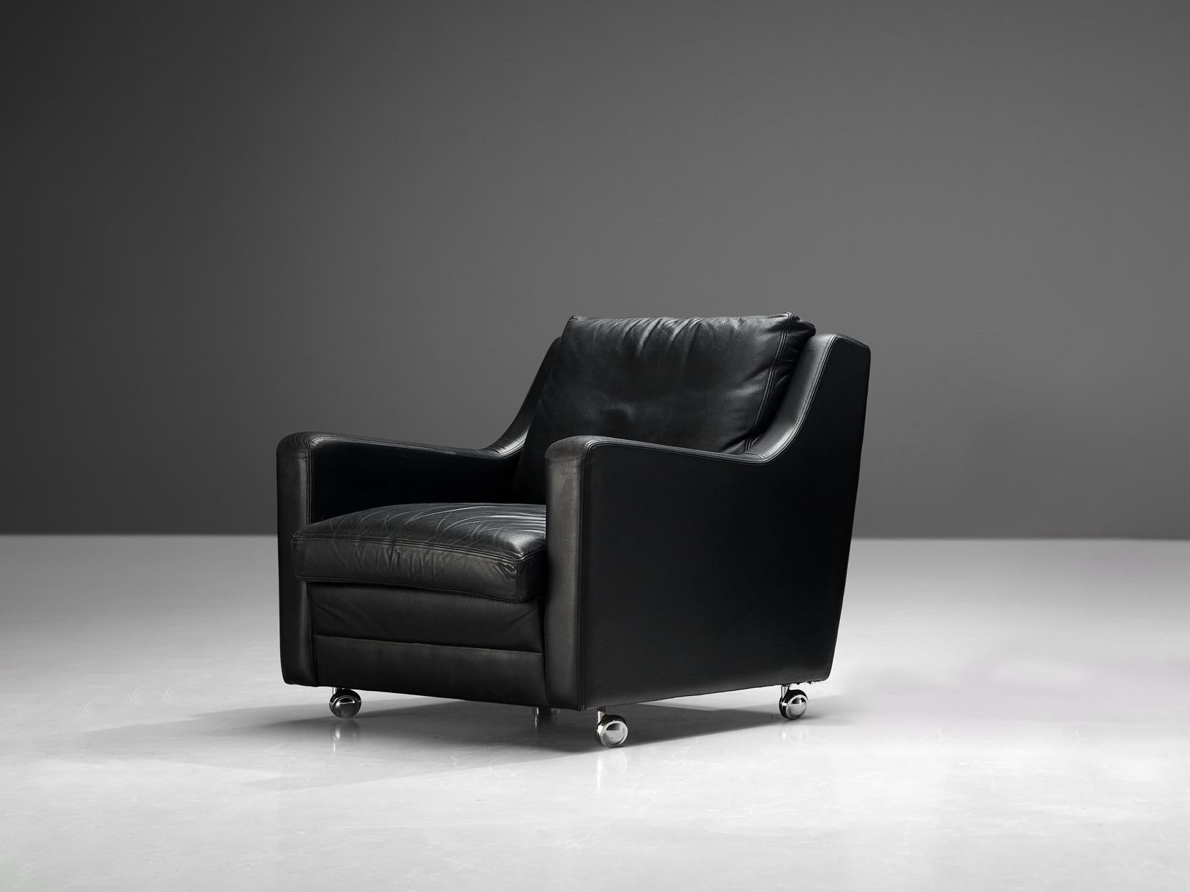 Lounge chair, black leather, metal, Europe, 1970s

This exquisite easy chair showcases a design defined by elegant, clear lines, enhancing their sculptural allure. The backrest seamlessly transitions into the armrests, forming an intriguing sharp