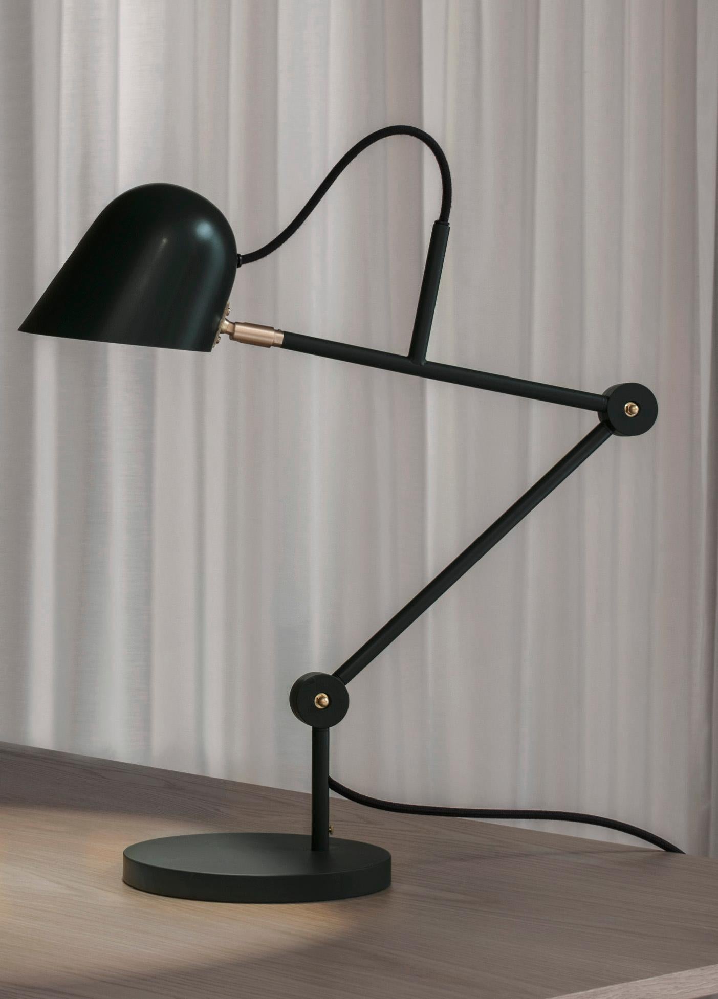 'Streck' adjustable table lamp by Joel Karlsson for Örsjö in Black.

Executed in powder-coated steel with brass details, the 'Streck' series is both timeless and refined in its minimalism. Clean geometric lines and understated simplicity make each