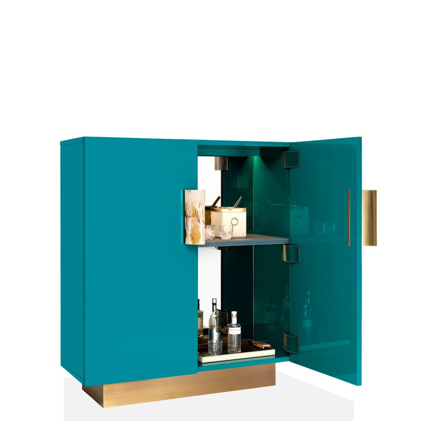 Sporting a timeless design, Stresa is a storage unit defined by essential lines and considered details. The structure in lacquered wood is proposed in a brand new water blue finish and rests on a burnished brass base. Two doors open to reveal the
