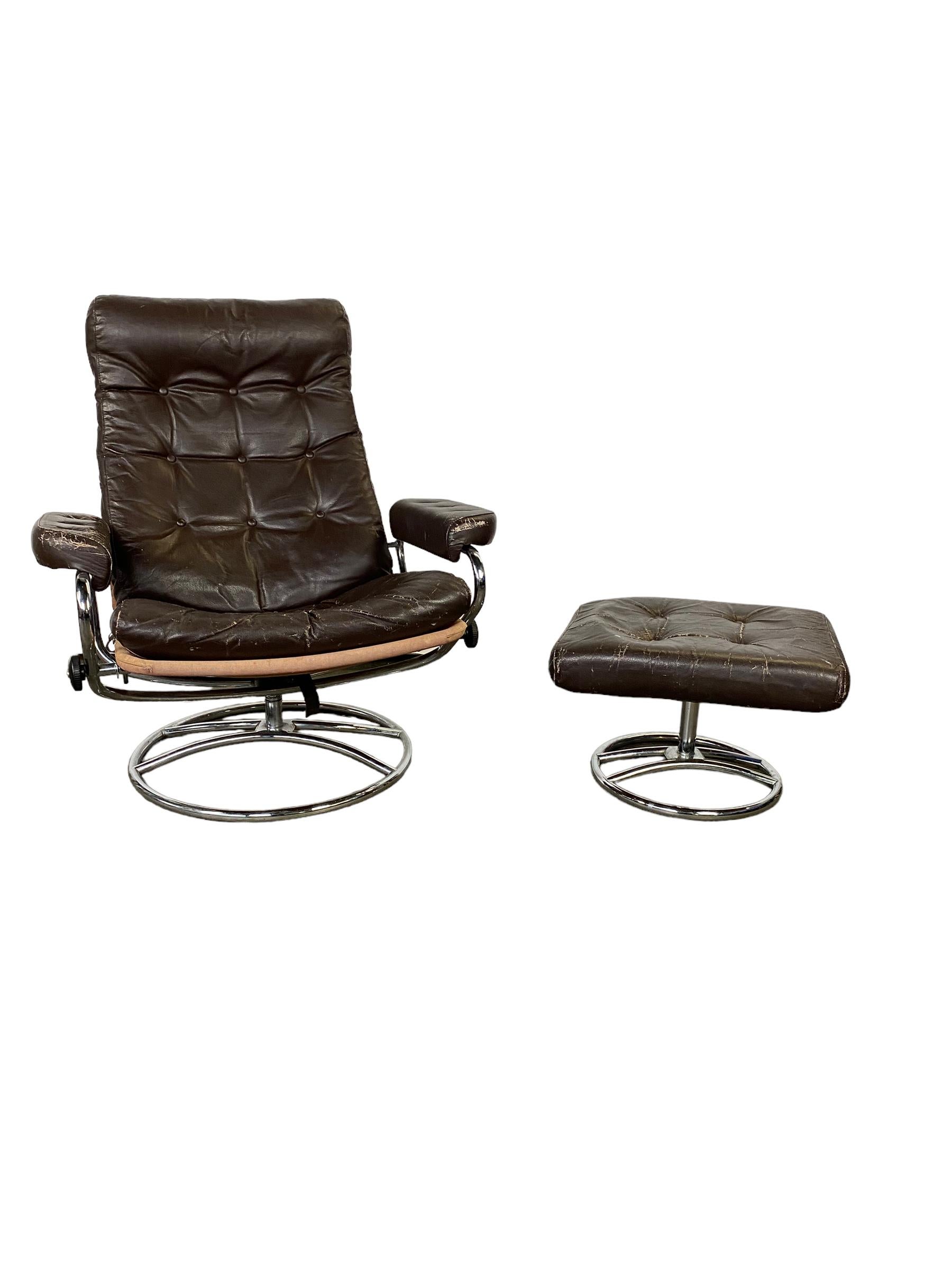 Stressless reclining lounge chair and ottoman in the style of Ekornes. Manufactured by Chairworks. Elegant mid century Scandinavian design with tubular bent chrome frame and espresso dark brown leather cushion. Lounge in comfort with this timeless