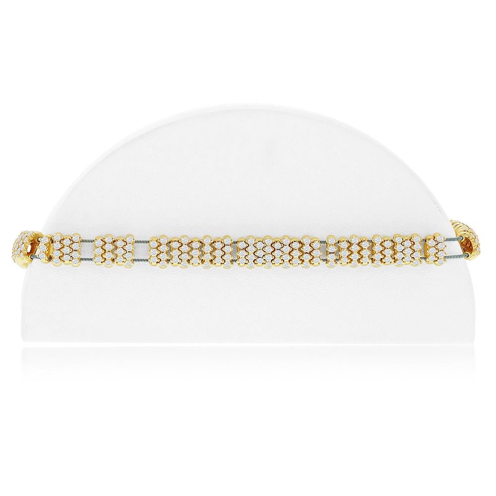 Stretch diamond flex bangle set in 14K yellow gold. The total diamond weight is 5.30 carats. The stones are G color and the clarity is SI1-SI2. Each stone weighs .025 carats. This Italian made piece is available in white gold.