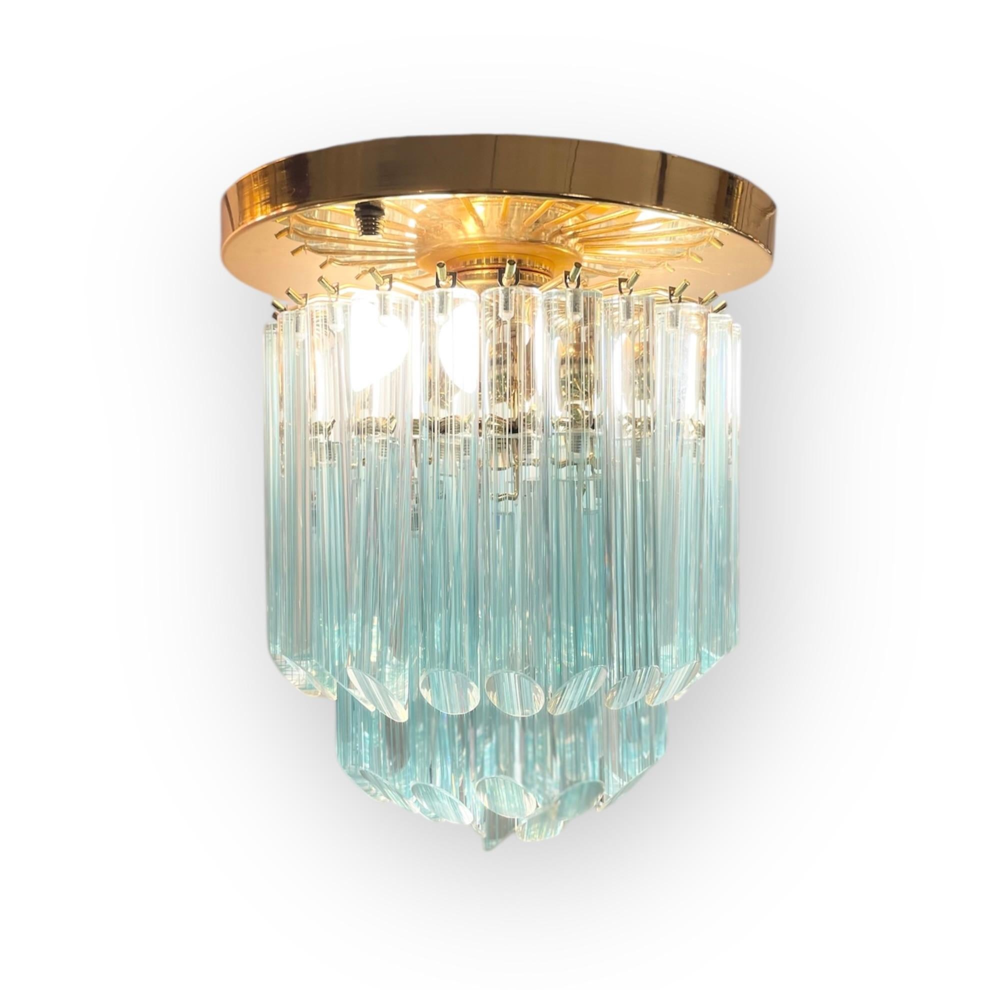 Pop and classic flush-mounted pendant light made of 44 blue striated full-tubes Murano glass suspended on a golden structure. Made in Venice, Italy, in the 1980’s.
-
Produced in: Murano, Venice, Italy
Design period: 1980s
Materials: glass,