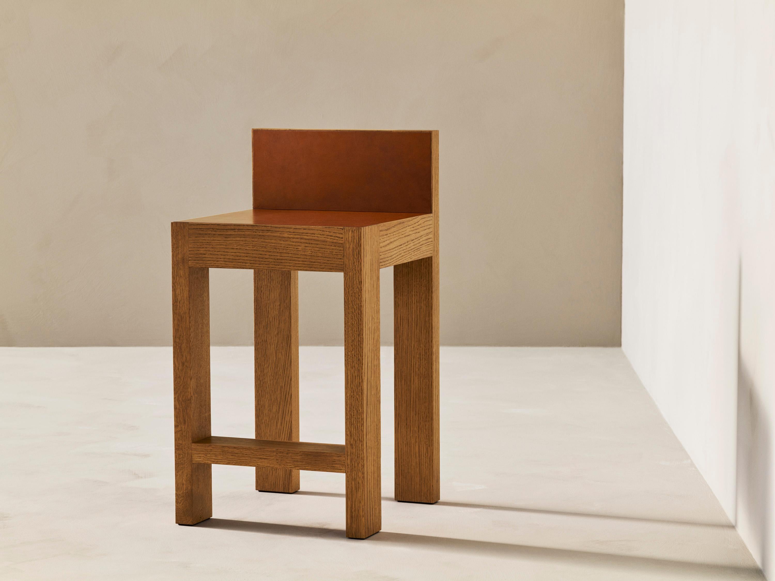 Strict Counter Stool by Veermakers
Dimensions: L 42 x H 82,5-65 cm. 
Materials: Oak Classic with a satin clear coat / Leather Shoulder Cognac.

About: After years of successful collaboration on luxury interior design projects, Louise Liljencrantz