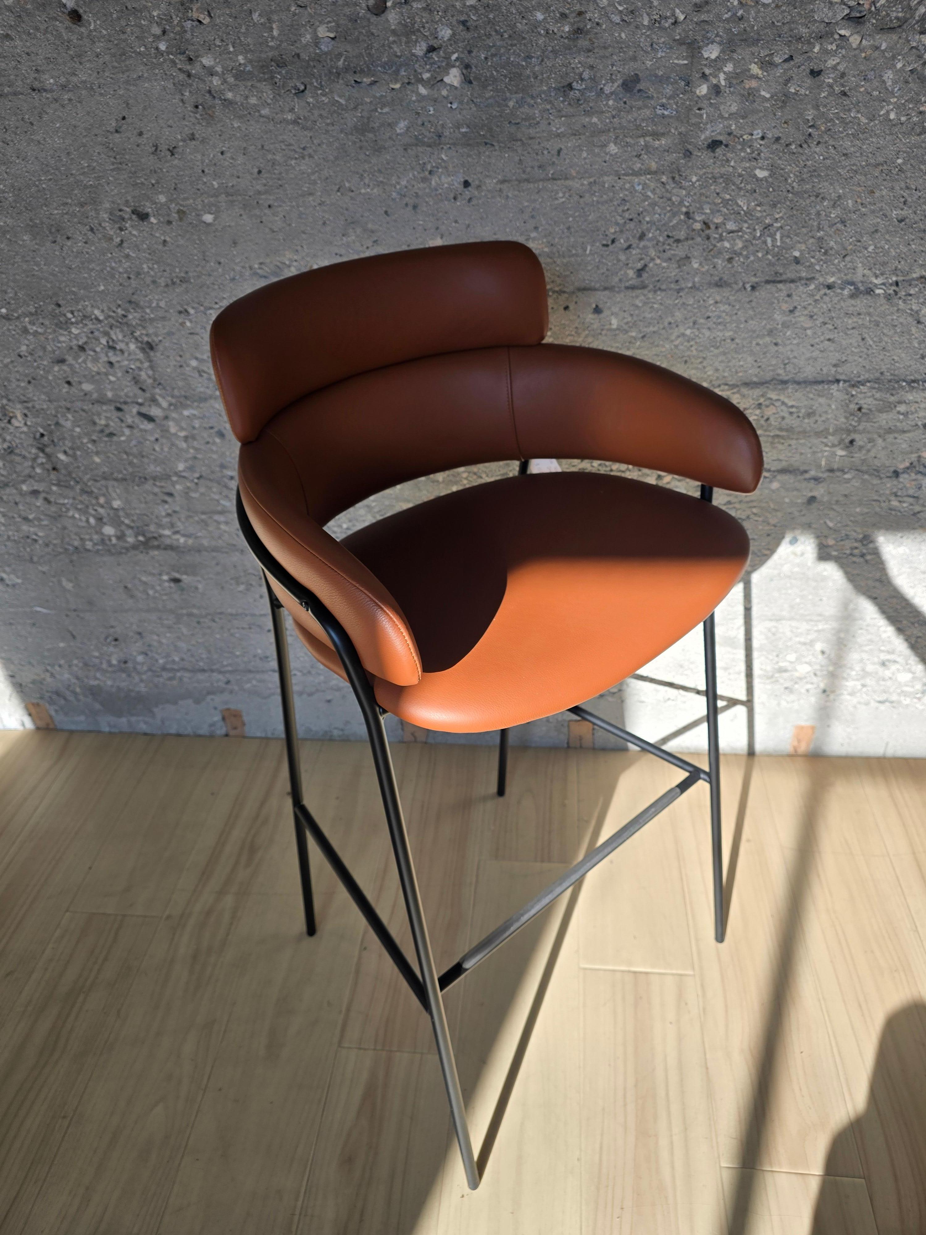 It’s composed of a plywood panel, curved, padded with polyurethane foam and upholstered with fabrics chosen by the customer. The upholstery on our chairs is made of flame-retardant fabric and flame-resistant foam.

Finish: Black base / leather
