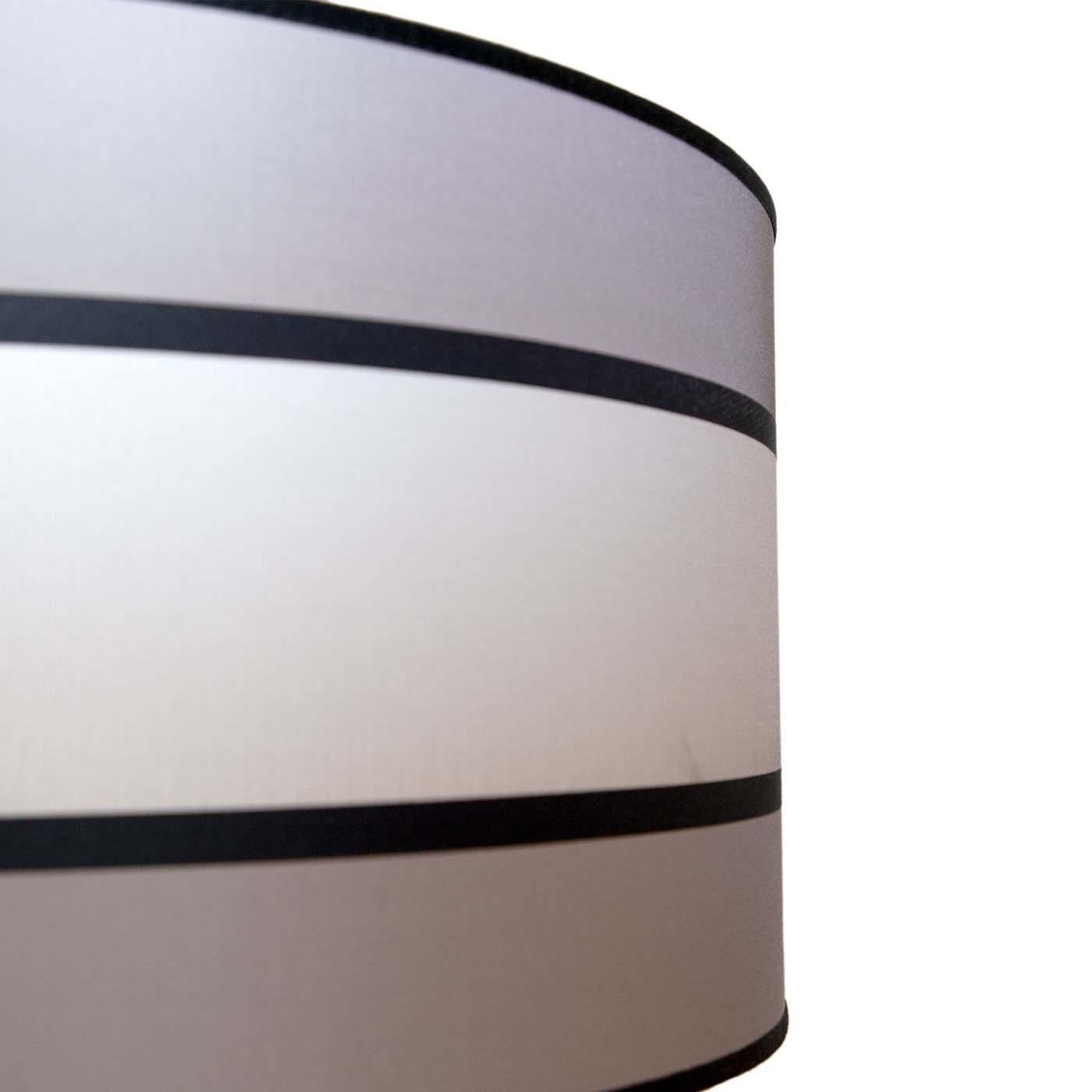 Part of the Peca Italia Collection, the Strike Stripe Lighting Fixture is perfect for illuminating a dining room, bedroom or living area. With grand dimensions and a cylindrical shape, it features a structure in light iron and a shade in PVC covered